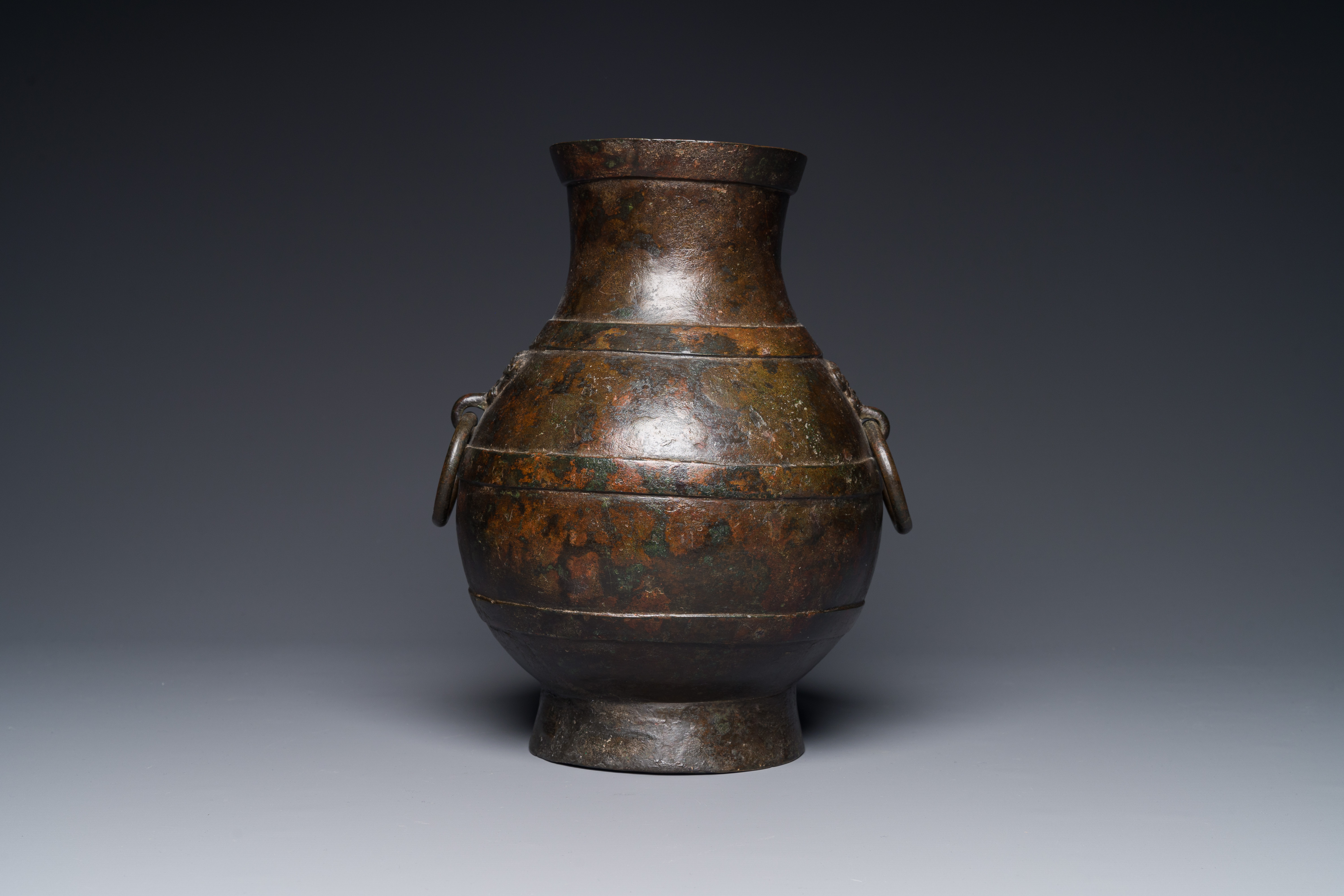 A Chinese bronze 'hu' vase with Han-style taotie handles on wooden base, Ming - Image 6 of 12