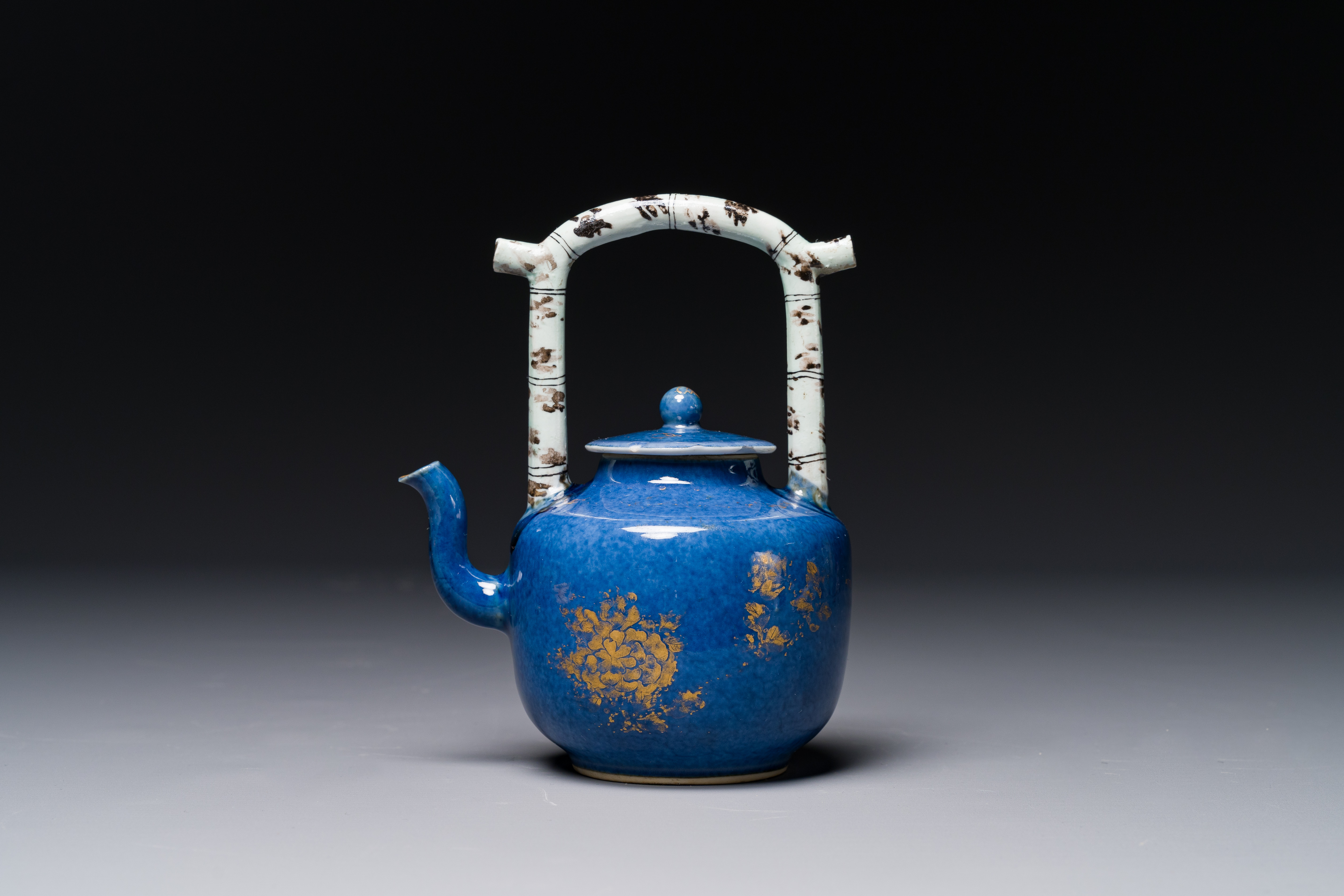 A Chinese gilt-decorated powder-blue teapot and cover with a faux-bamboo handle, Kangxi