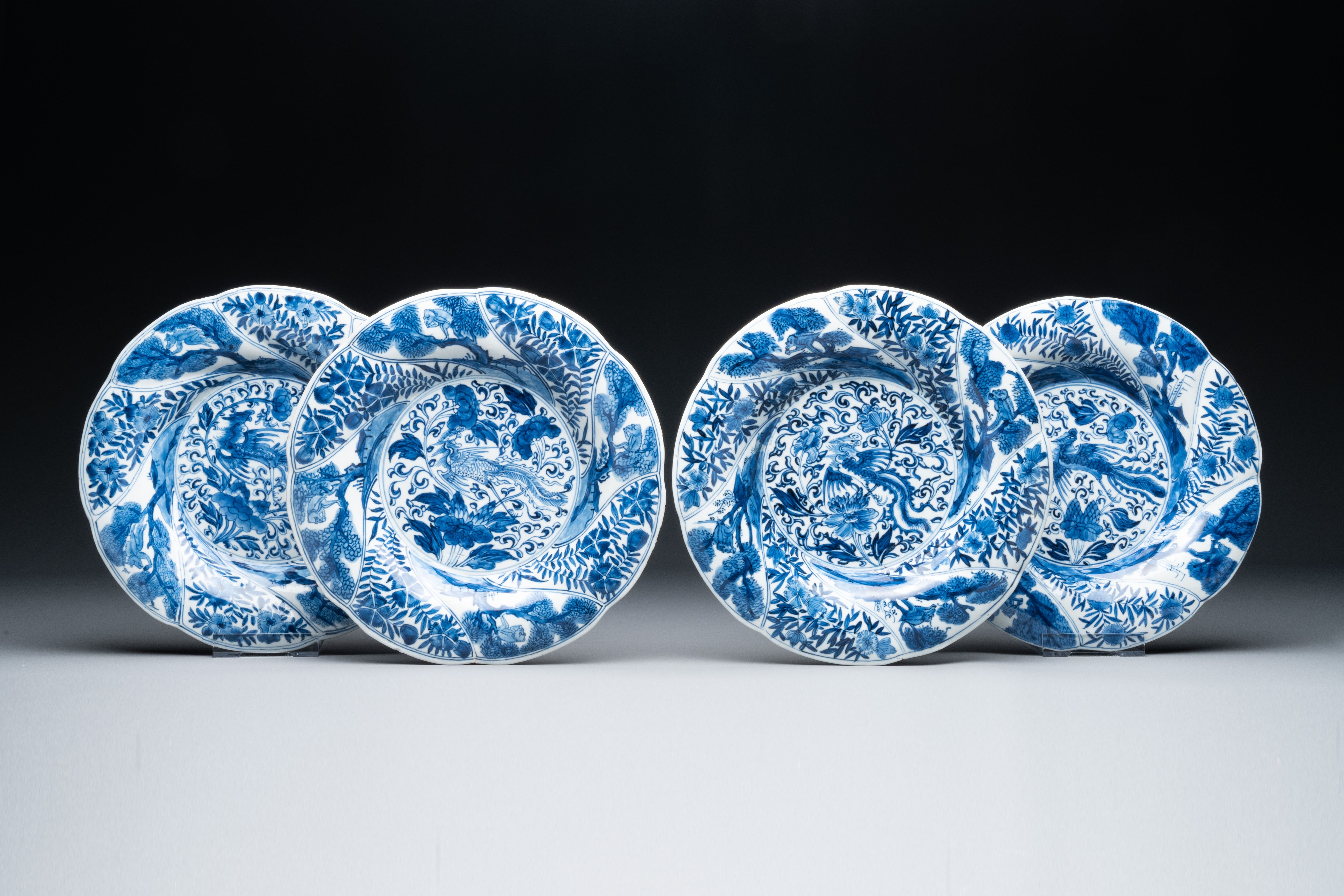 Four Chinese blue and white lobed 'phoenix and monkey' plates, flower mark, Kangxi