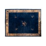 A large Chinese dark-blue-ground carpet with floral design, 19/20th century