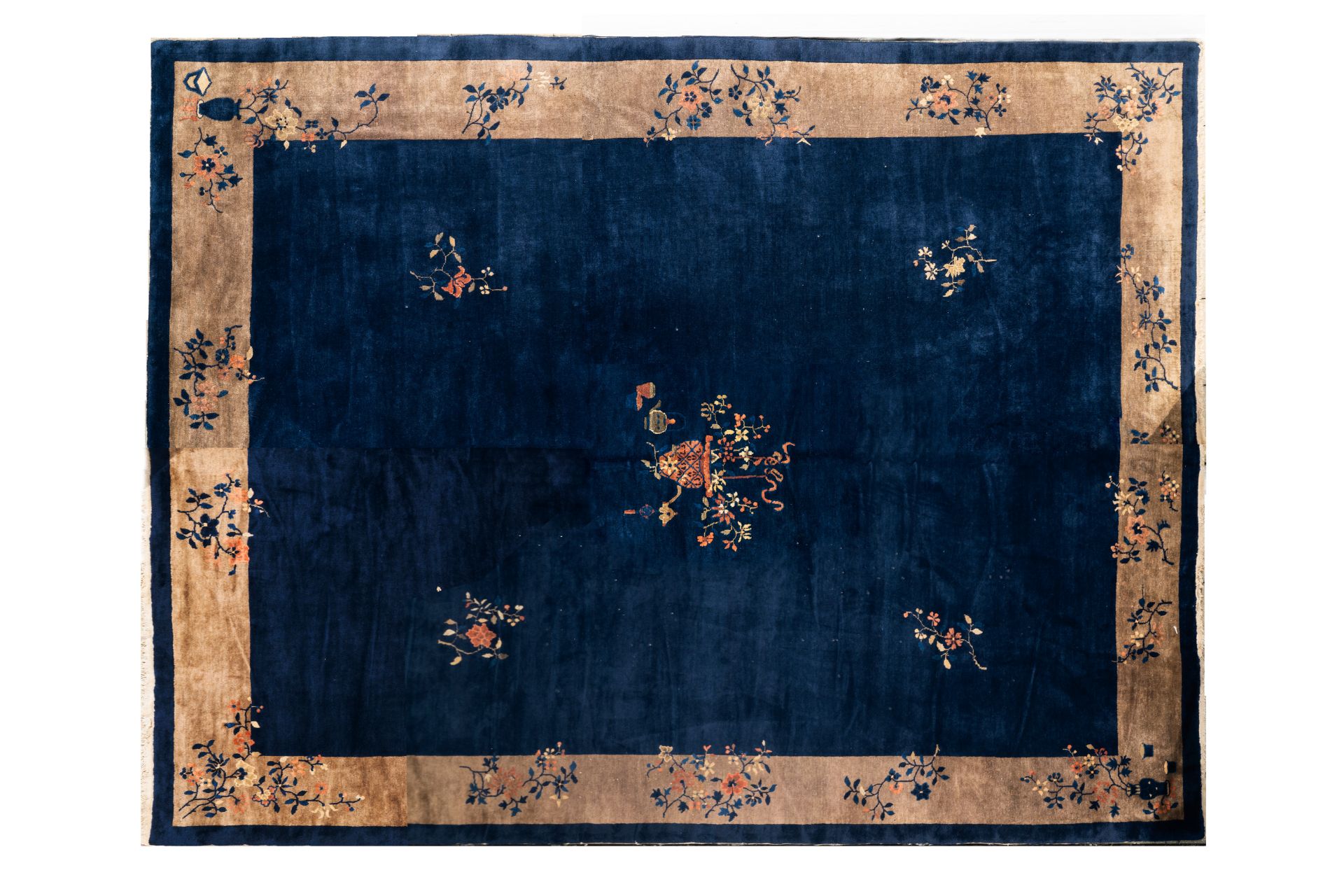 A large Chinese dark-blue-ground carpet with floral design, 19/20th century