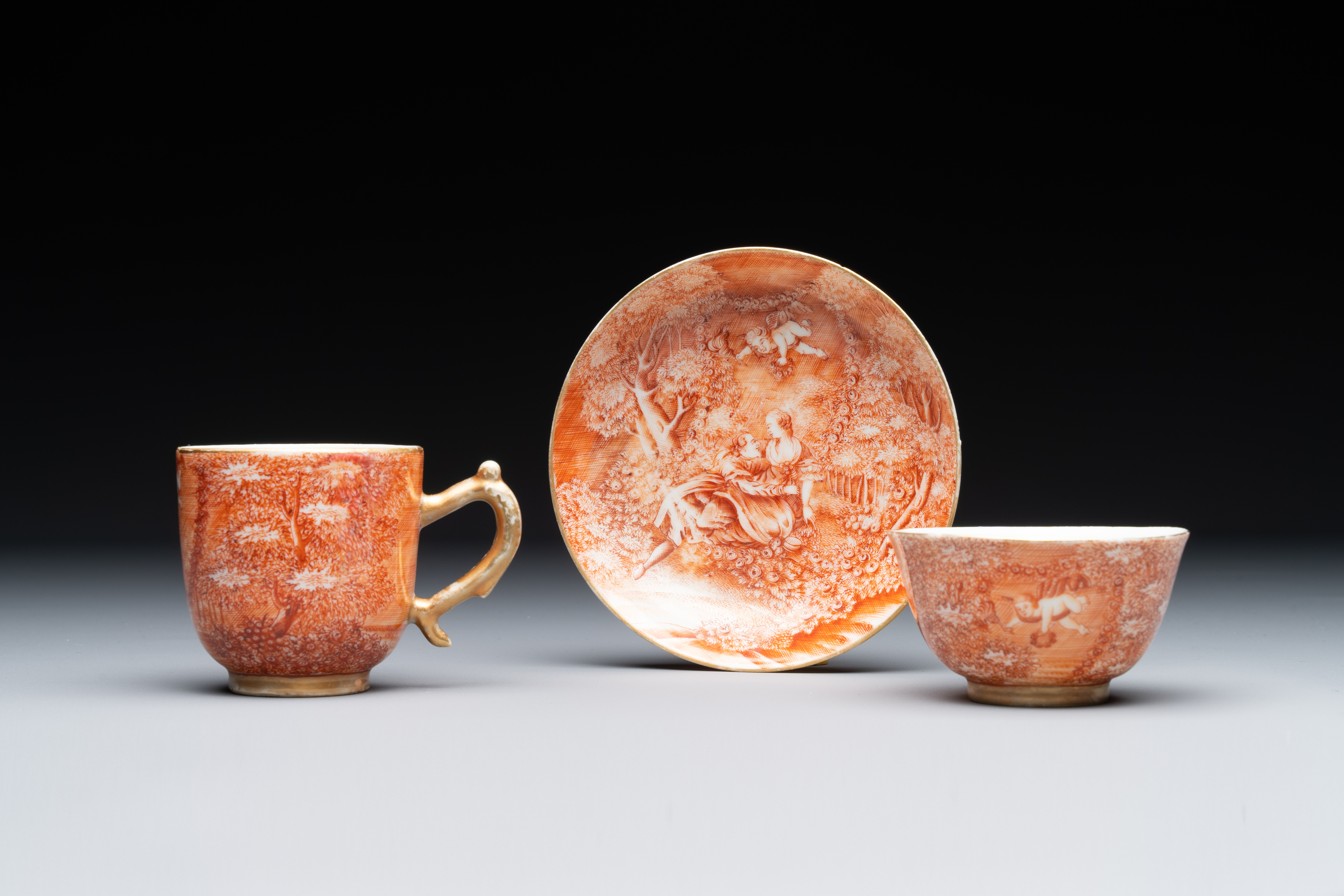 Two rare Chinese iron-red-decorated 'European scene' cups and a saucer, Qianlong - Image 2 of 8