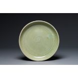 A Chinese Longquan celadon dish with anhua floral design, Ming