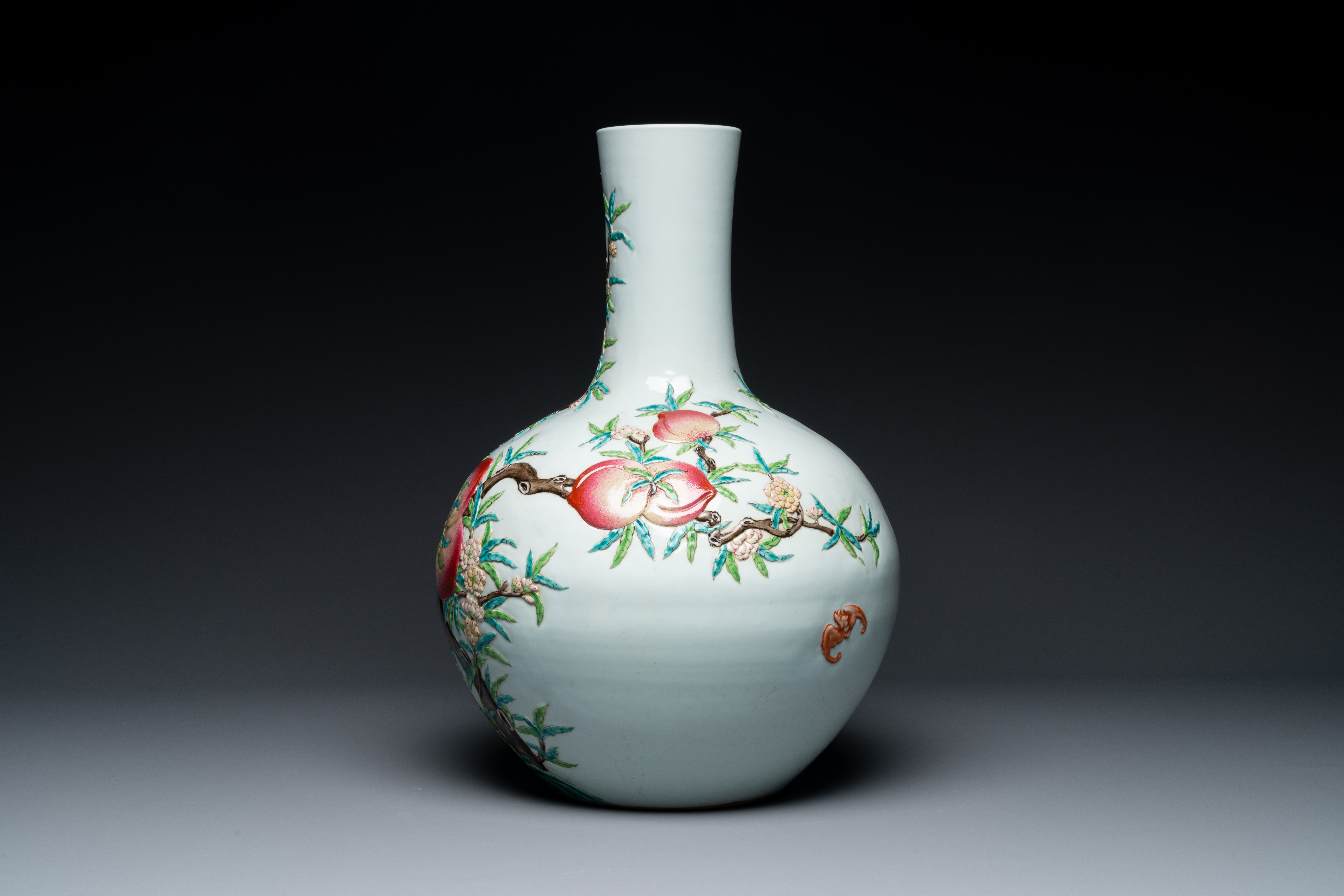 A Chinese famille rose relief-molded 'tianqiuping' vase with nine peaches, Qianlong mark, 19/20th C. - Image 2 of 6