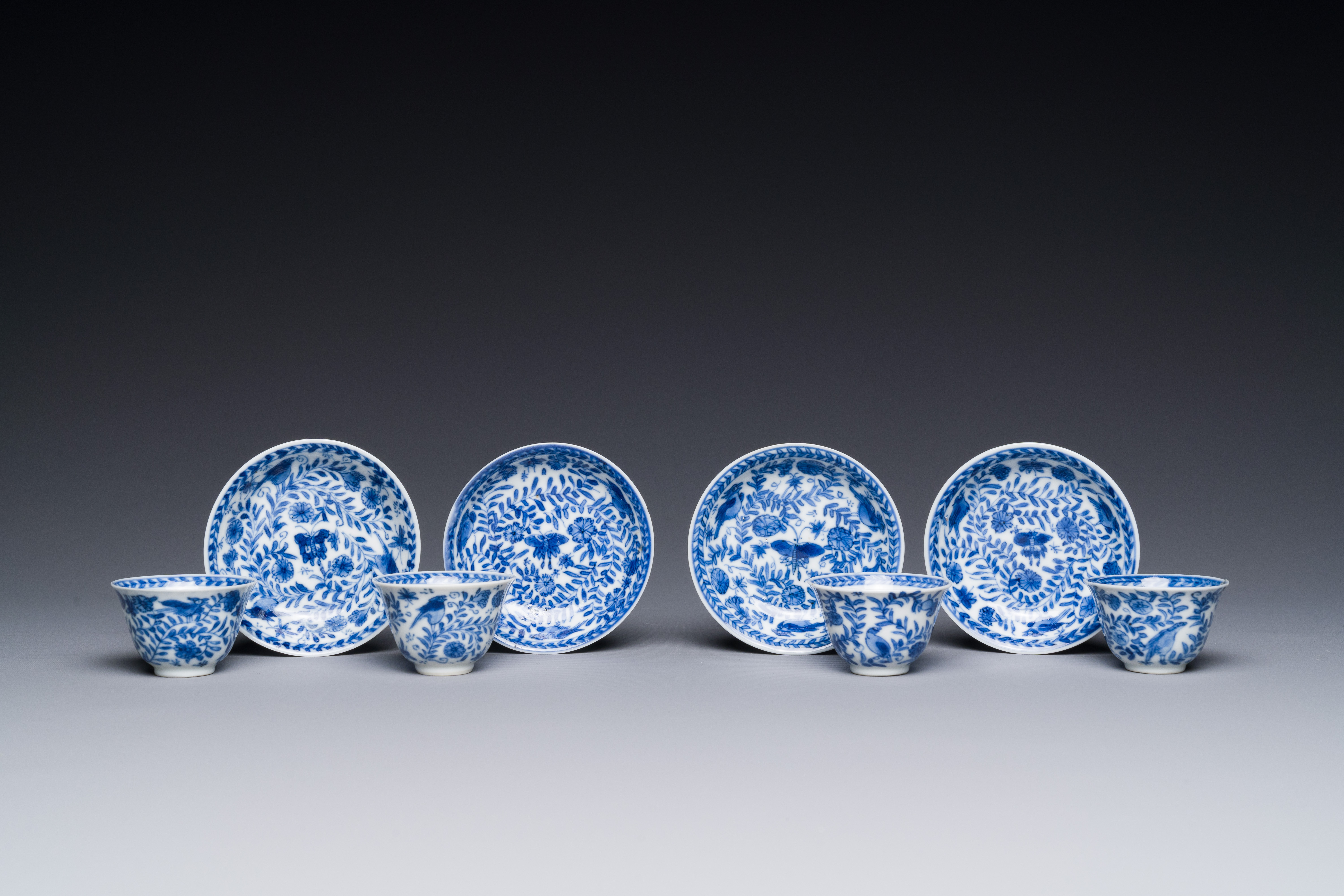 Four Chinese blue and white miniature cups and saucers, butterfly mark, Kangxi