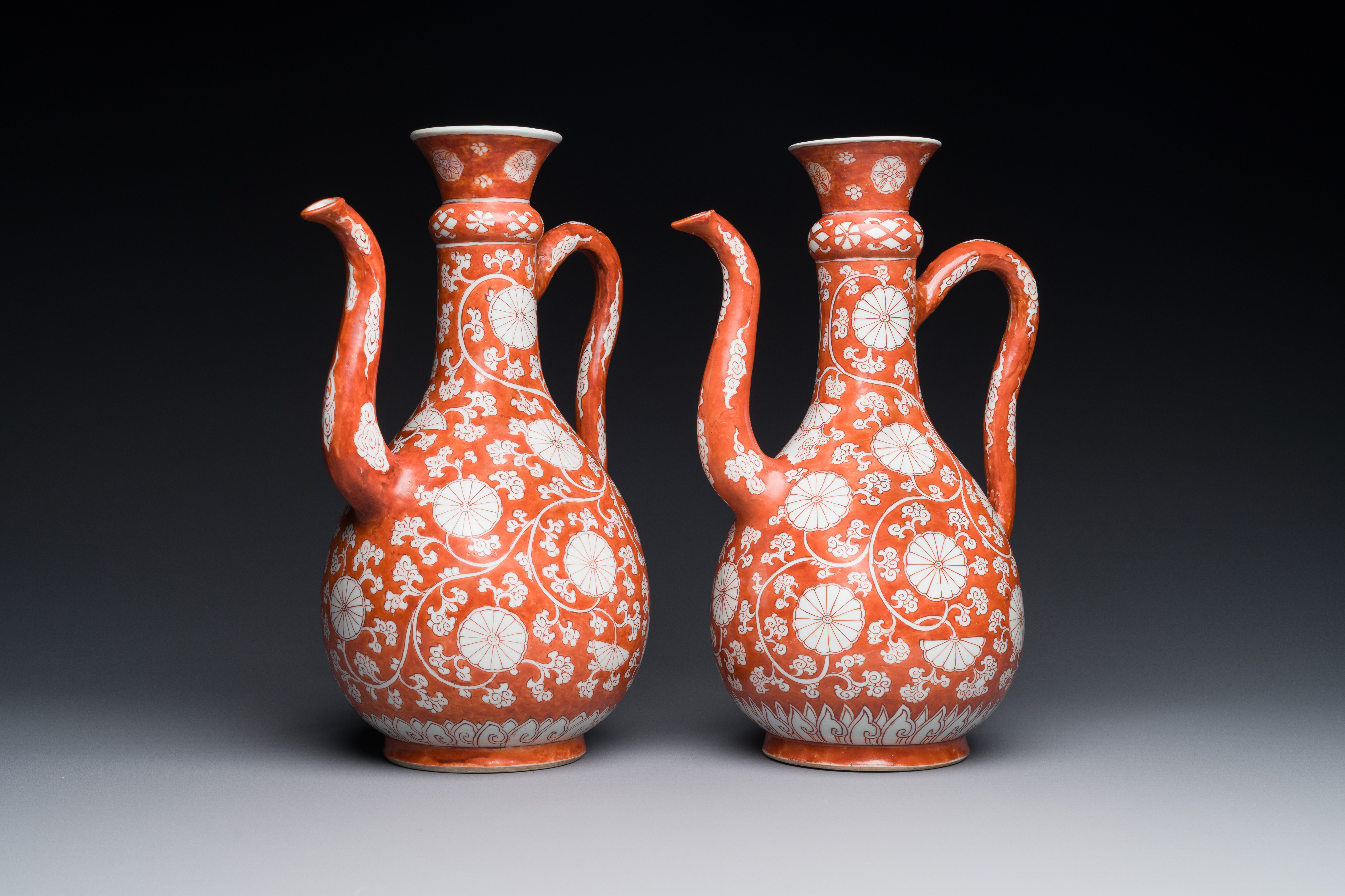 A pair of rare Chinese iron-red-enamelled 'chrysanthemum scroll' ewers, Kangxi