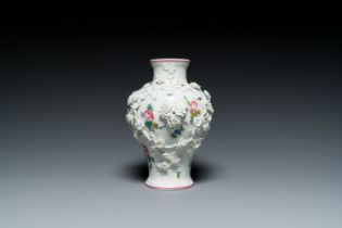 A Mennecy vase with applied floral design, France, DV mark, 18th C.