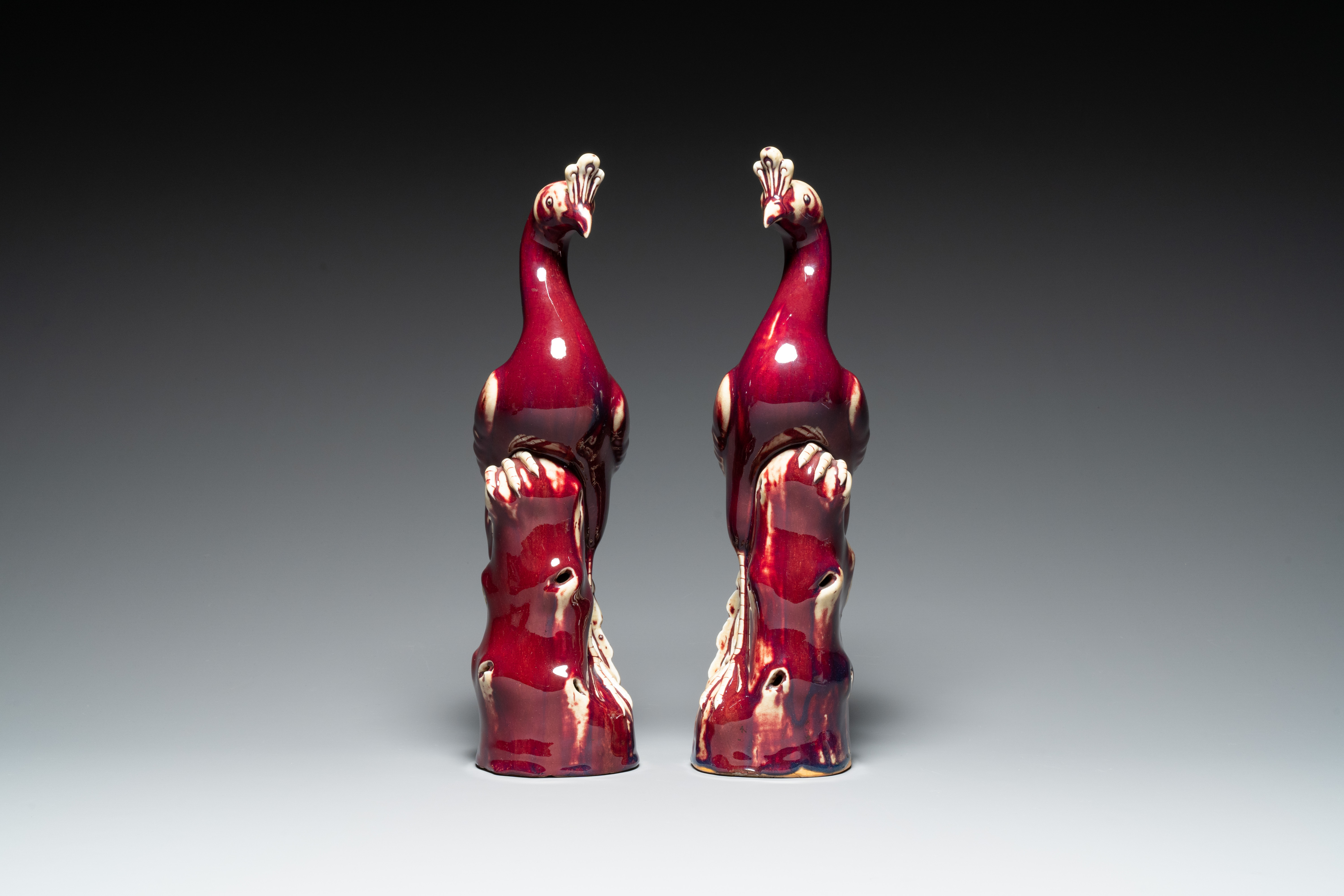 A pair of Chinese flambe-glazed models of peacocks on wooden stands, 19th C. - Image 3 of 7