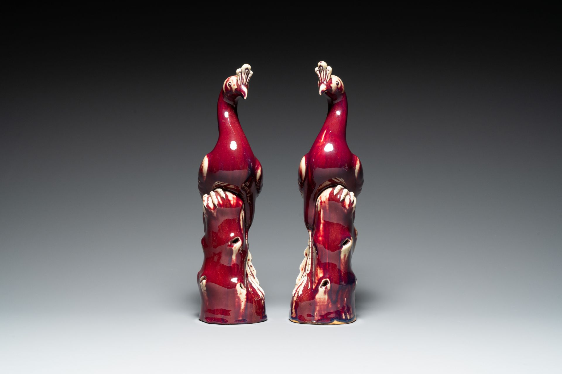 A pair of Chinese flambe-glazed models of peacocks on wooden stands, 19th C. - Image 3 of 7