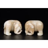 A pair of Chinese white and russet jade sculptures of elephants, Qianlong