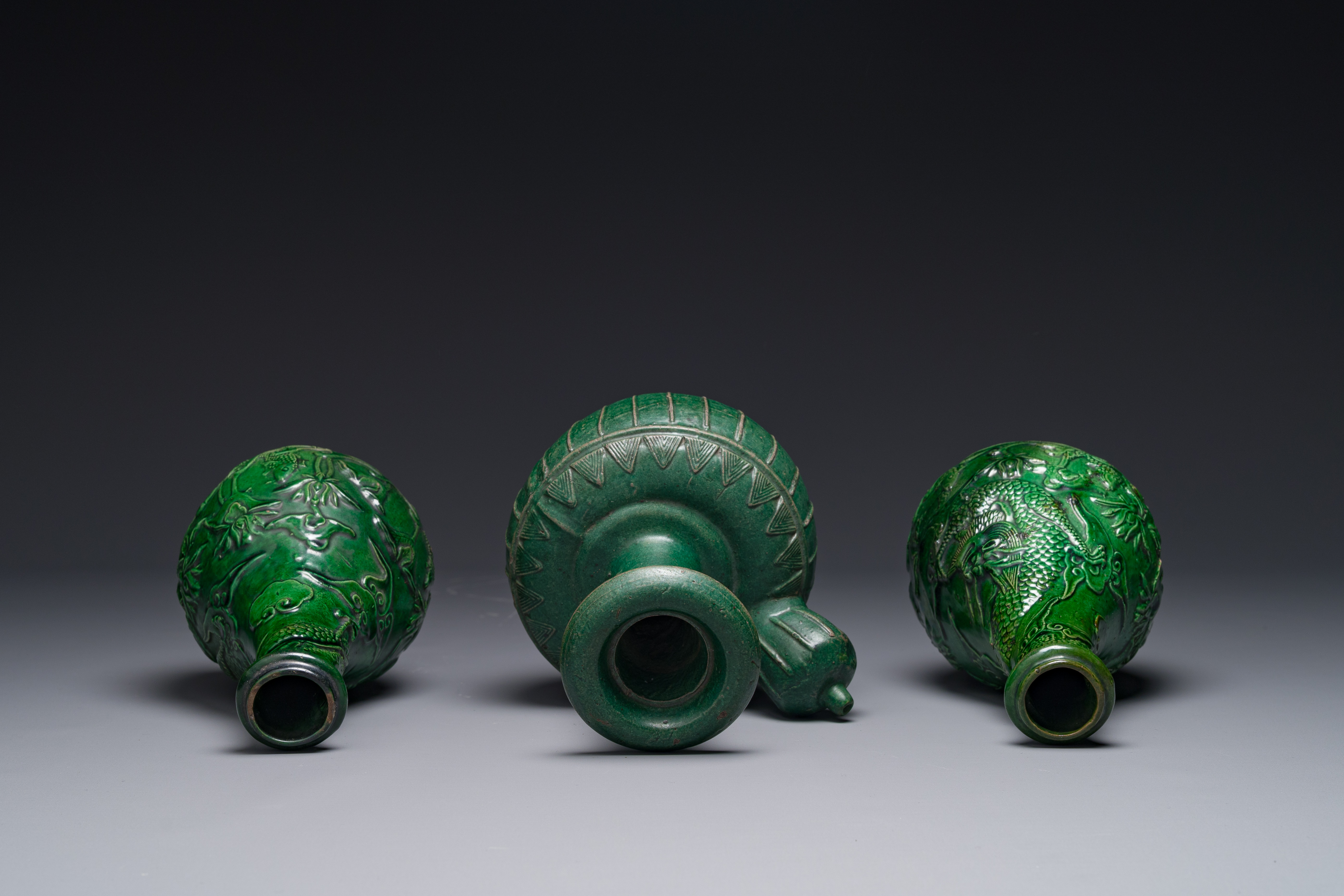 Two Chinese monochrome green-glazed stoneware 'dragon' vases and a kendi, Fujian kiln, late Ming - Image 3 of 4