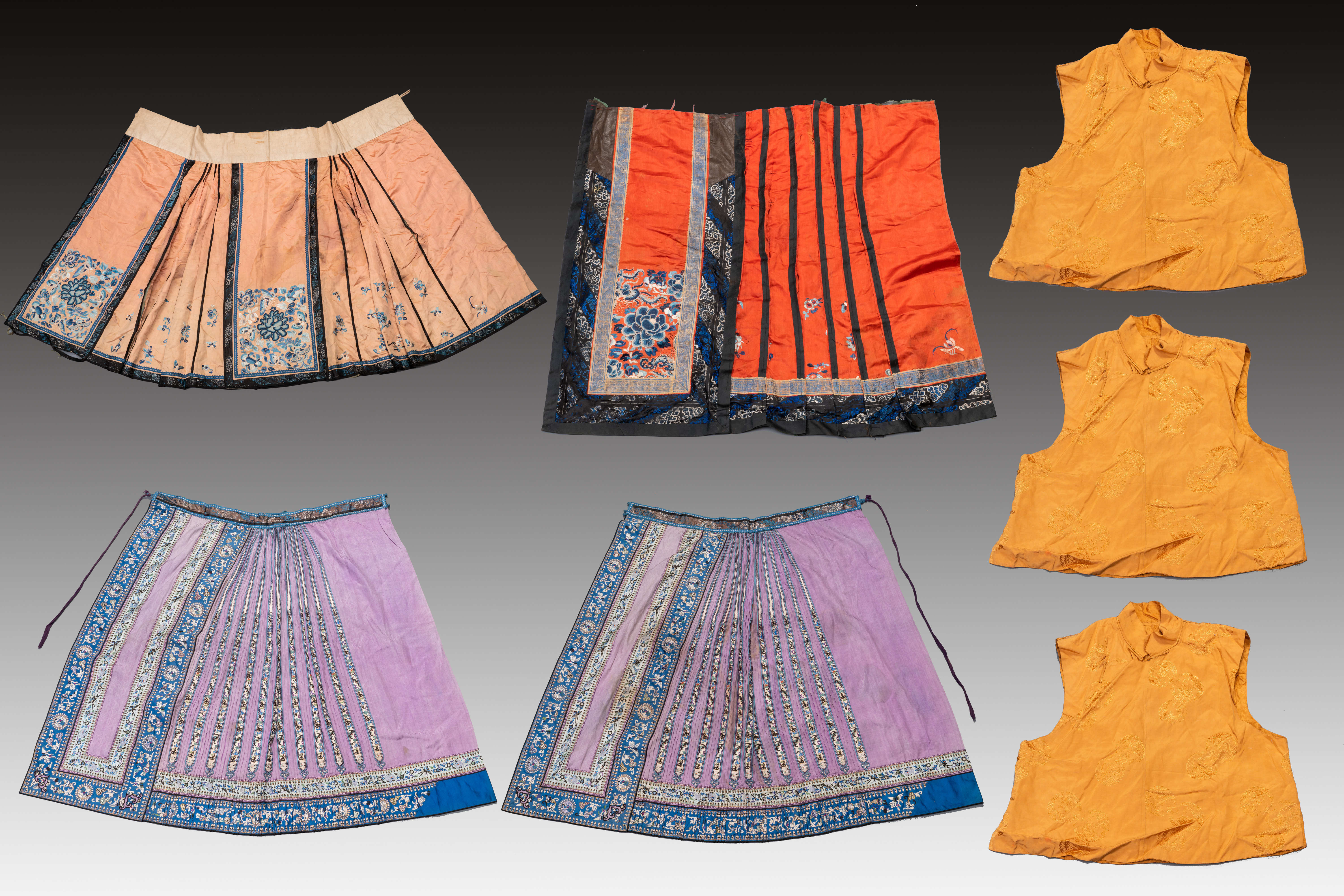 Four Chinese embroidered silk skirts and three yellow 'magua' jackets, 19/20th C.