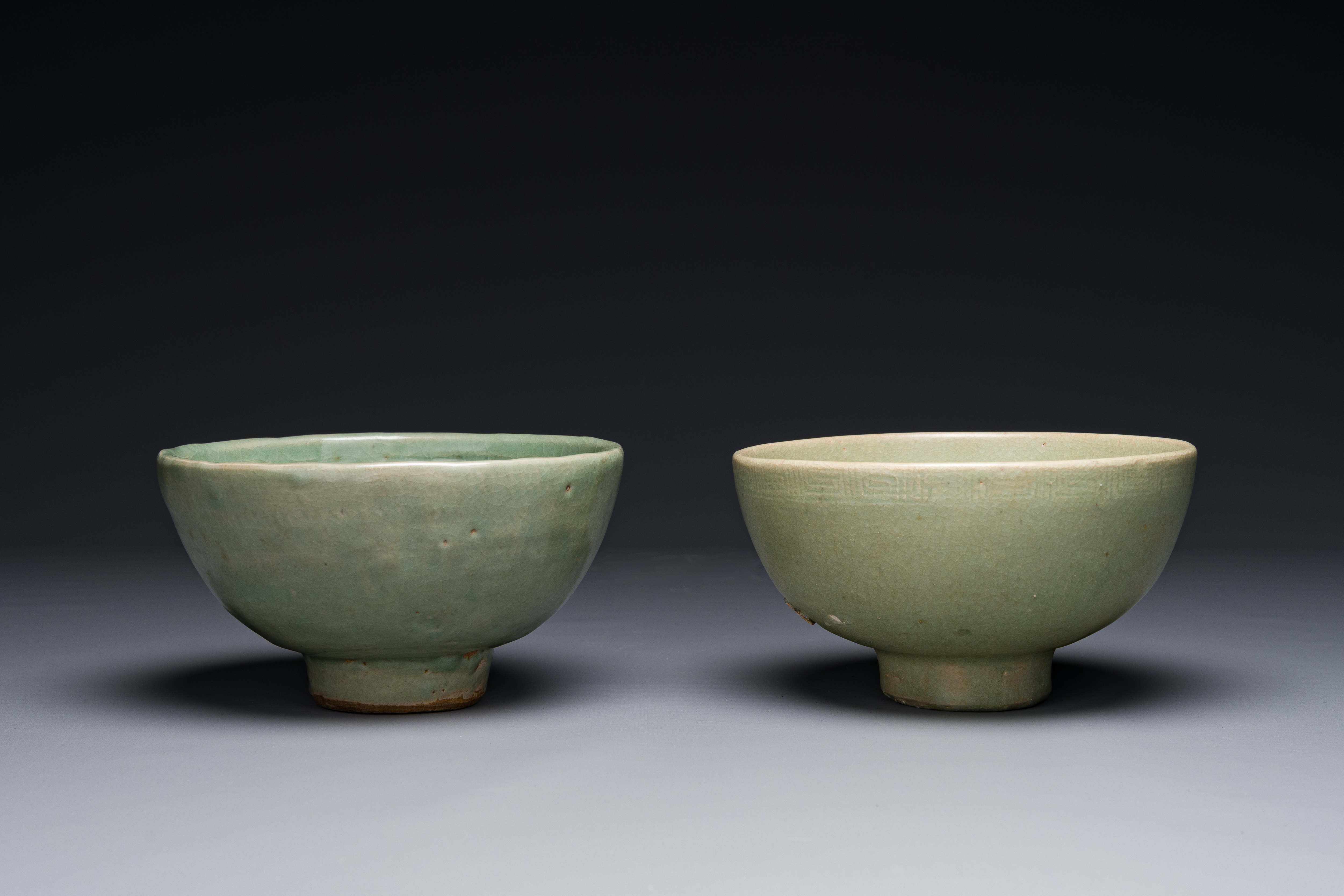 Two rare Chinese Longquan celadon bowls with figural design, Yuan