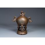 A large Chinese bronze censer and cover on stand decorated with six lions, 19th C.