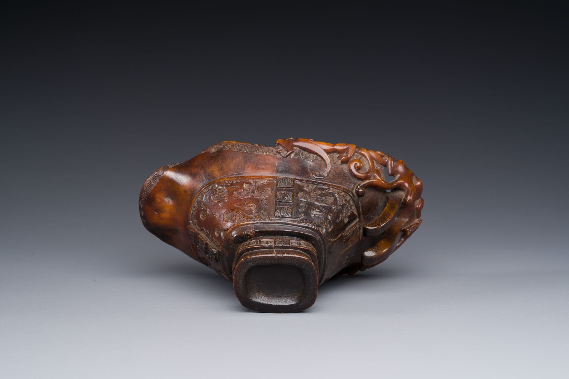 A Chinese carved rhinoceros horn 'libation cup' with chilong design, 17/18th C. - Image 8 of 8