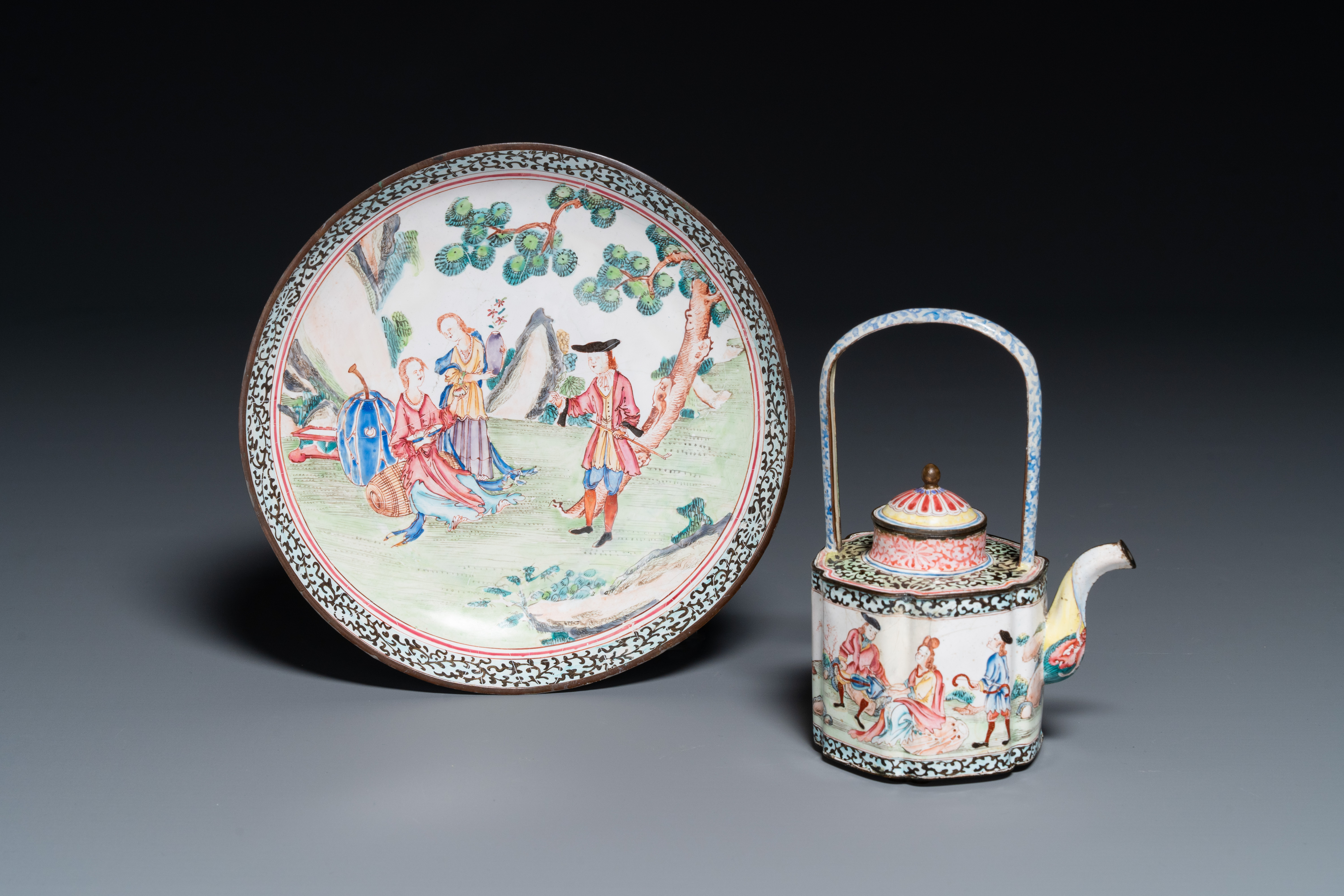 A Chinese Canton enamel 'European scene' plate and a teapot, Qianlong