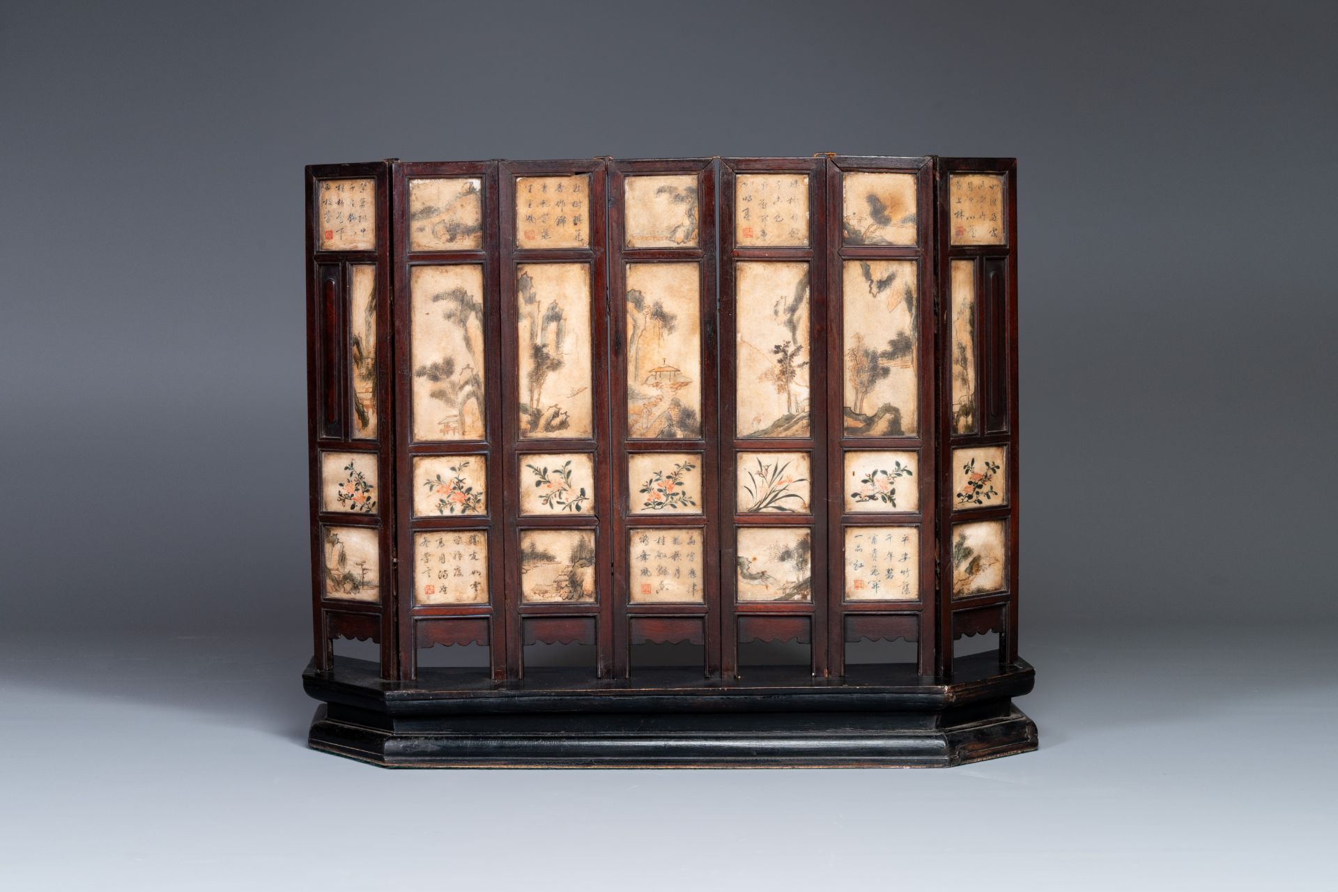 A Chinese seven-fold wooden table screen with painted marble plaques, 19th C. - Image 3 of 6