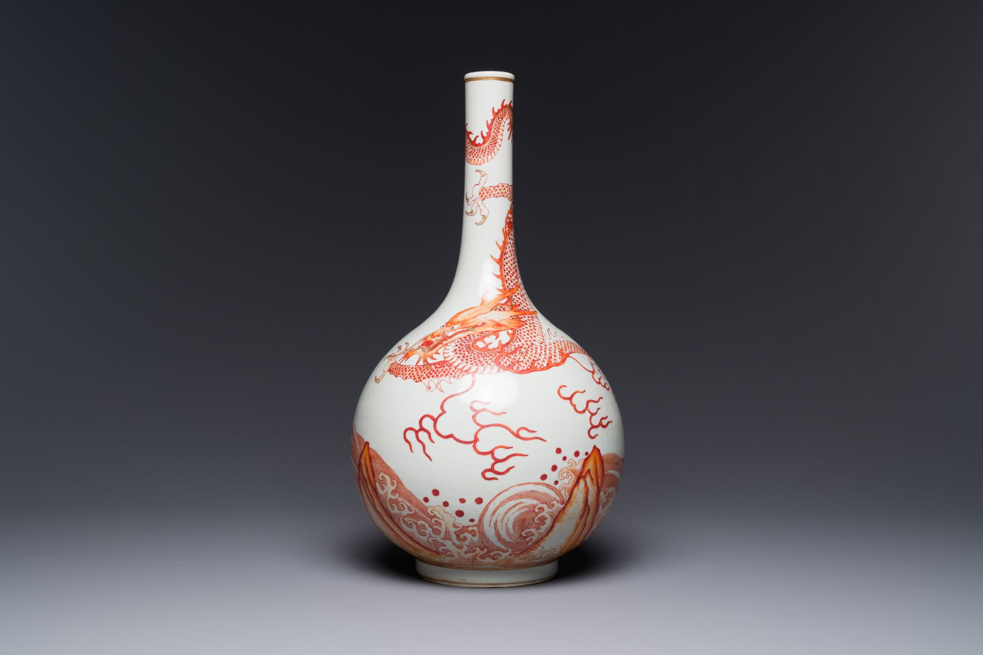 A Chinese iron-red-decorated and gilded 'dragon and carp' bottle vase, 19/20th C.