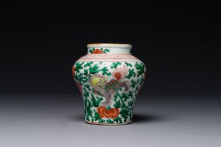 A small Chinese wucai 'Buddhist lion and peony scroll' jar, Transition period