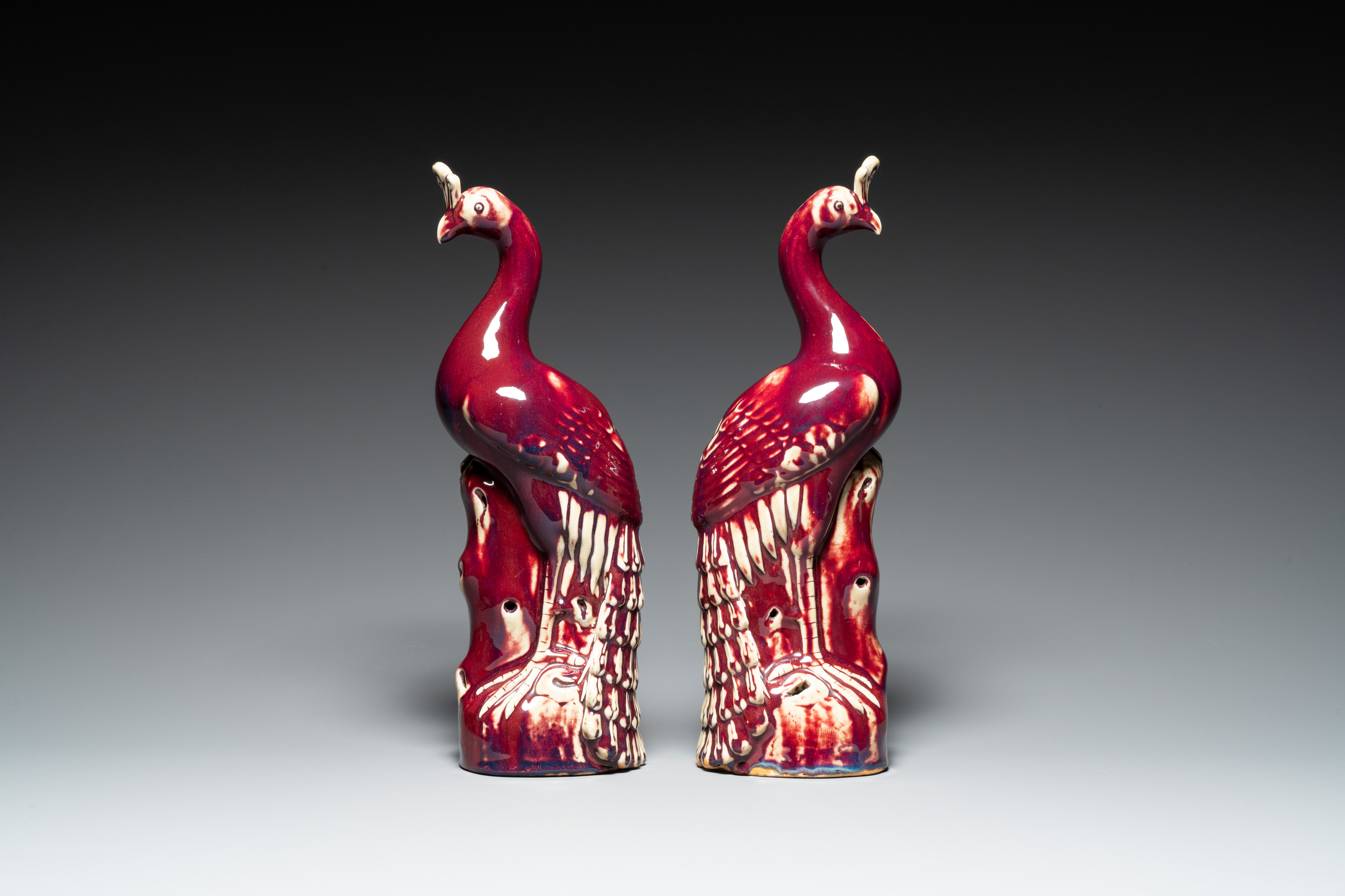 A pair of Chinese flambe-glazed models of peacocks on wooden stands, 19th C. - Image 2 of 7