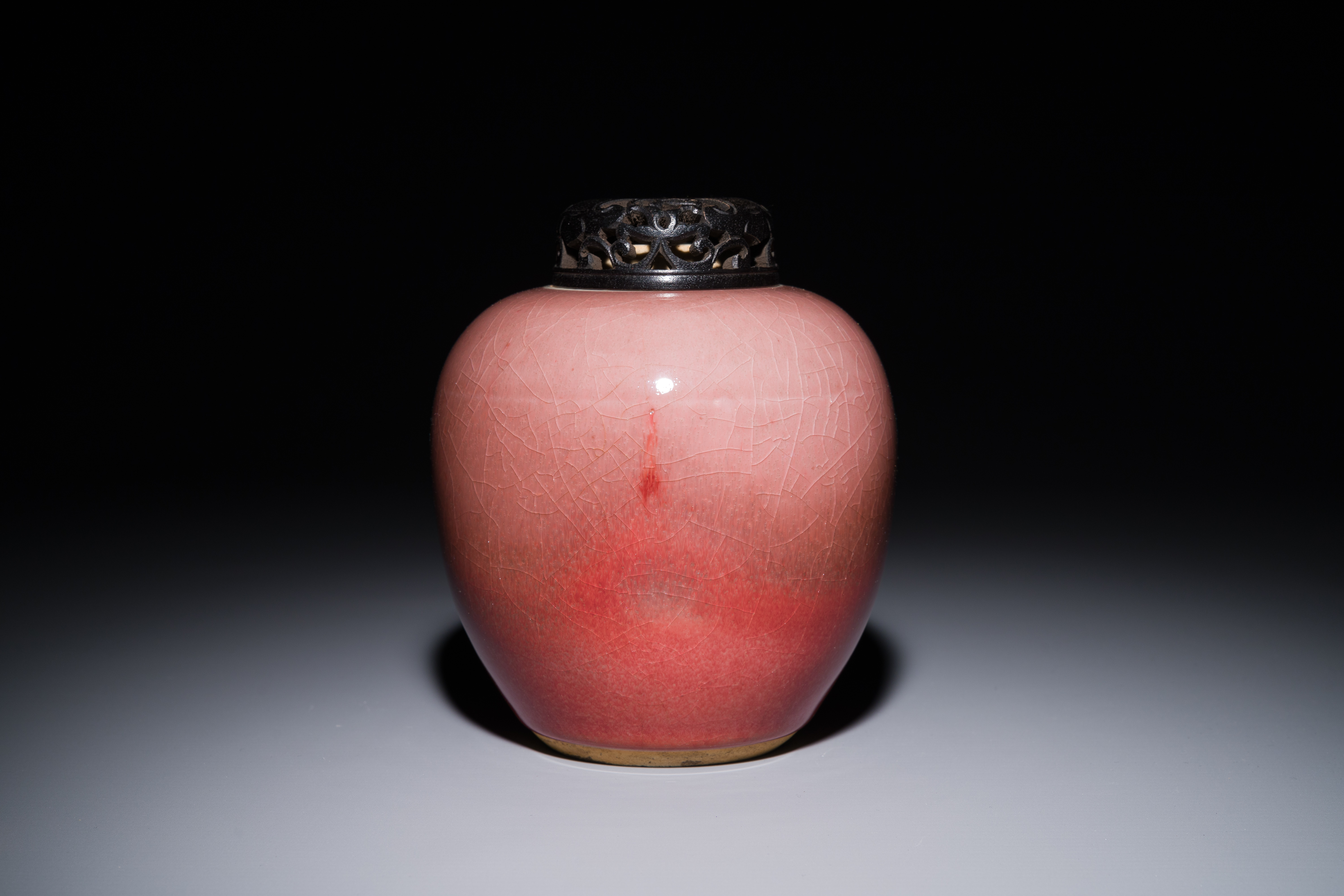 A Chinese monochrome copper-red-glazed ginger jar with a reticulated wooden cover, 18/19th C. - Image 2 of 5