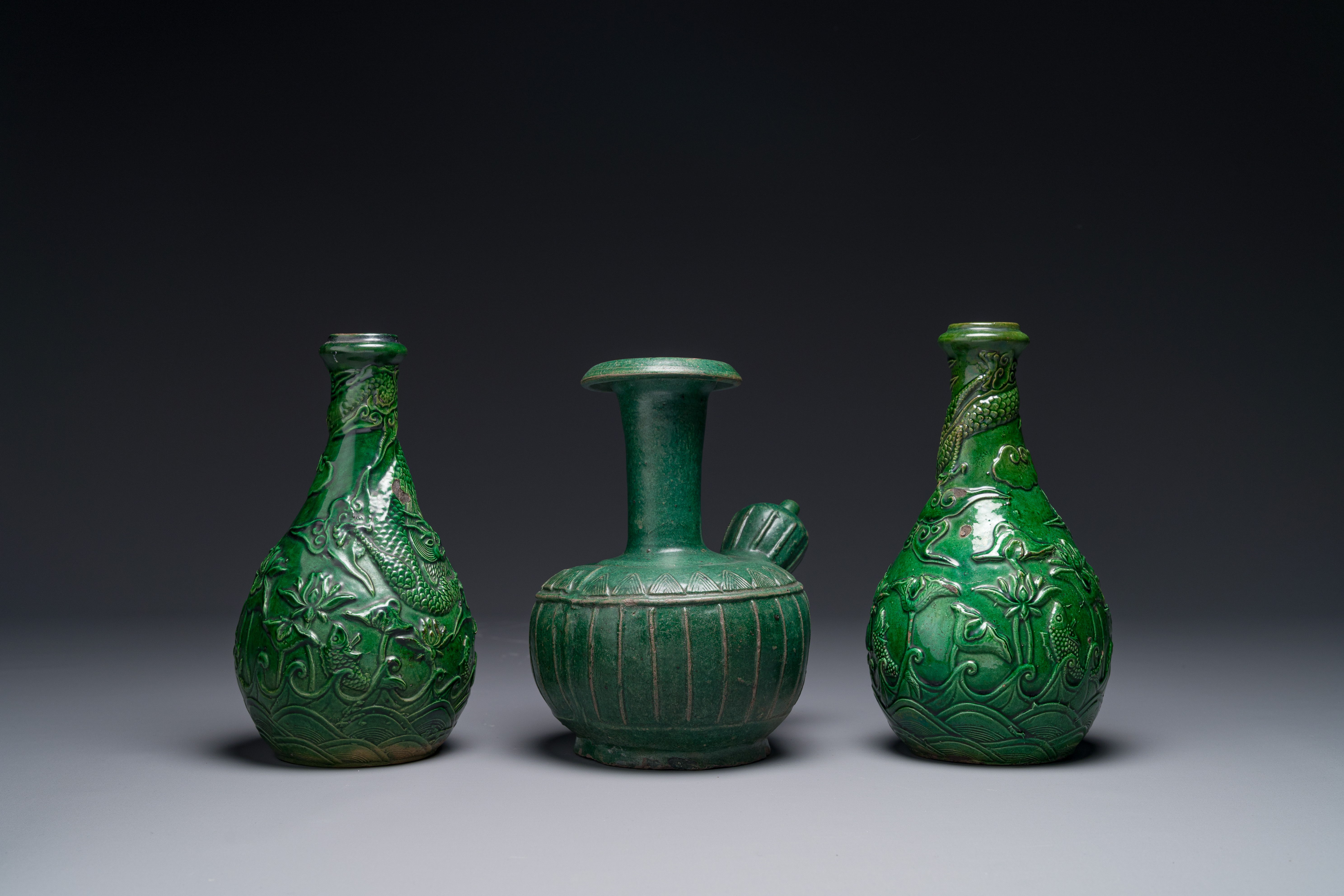 Two Chinese monochrome green-glazed stoneware 'dragon' vases and a kendi, Fujian kiln, late Ming - Image 2 of 4