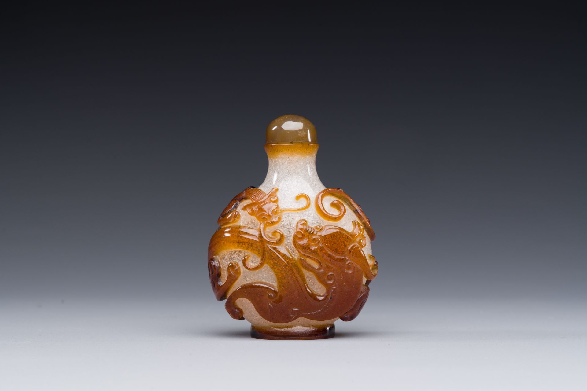 A rare Chinese brown-overlay white glass snuff bottle with chilong design, Qianlong/Jiaqing