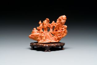 A Chinese red coral 'Eight Immortals' group on wooden stand, 19/20th C.