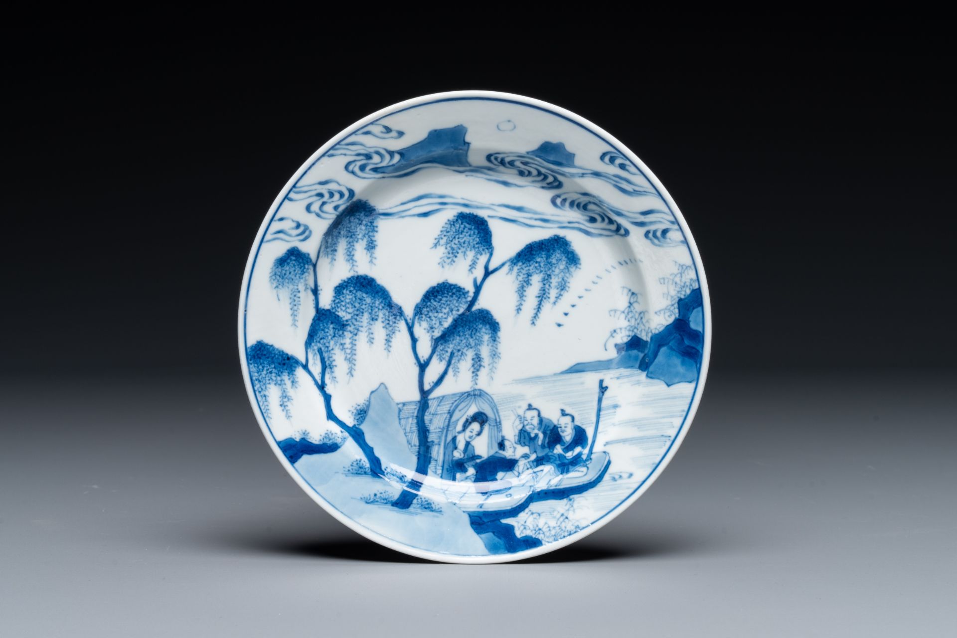 A Chinese blue and white plate with a breastfeeding woman and fishermen on boats, Chenghua mark, Kan
