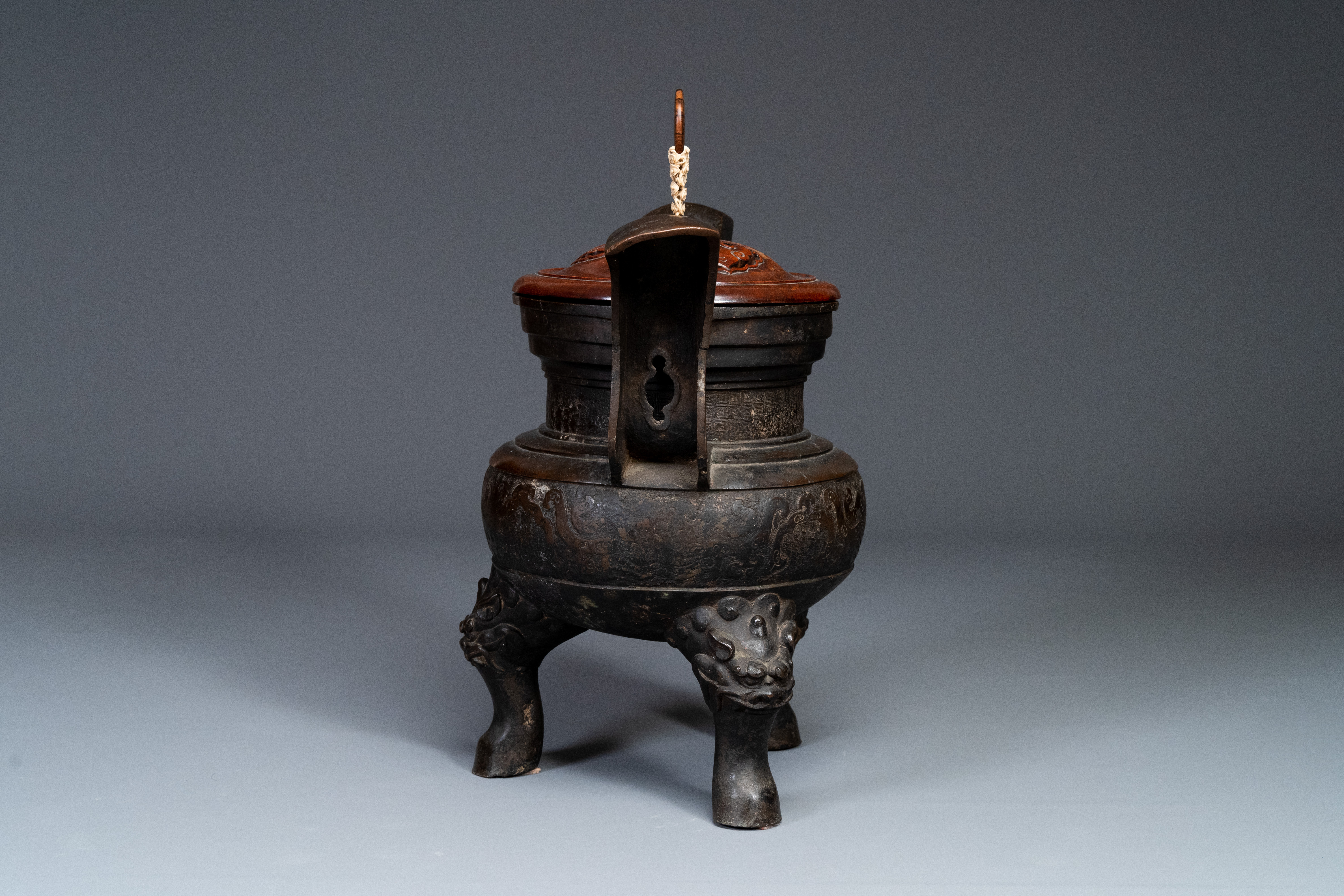 An important Chinese bronze tripod 'taotie' censer with wooden lid, Ming - Image 5 of 18