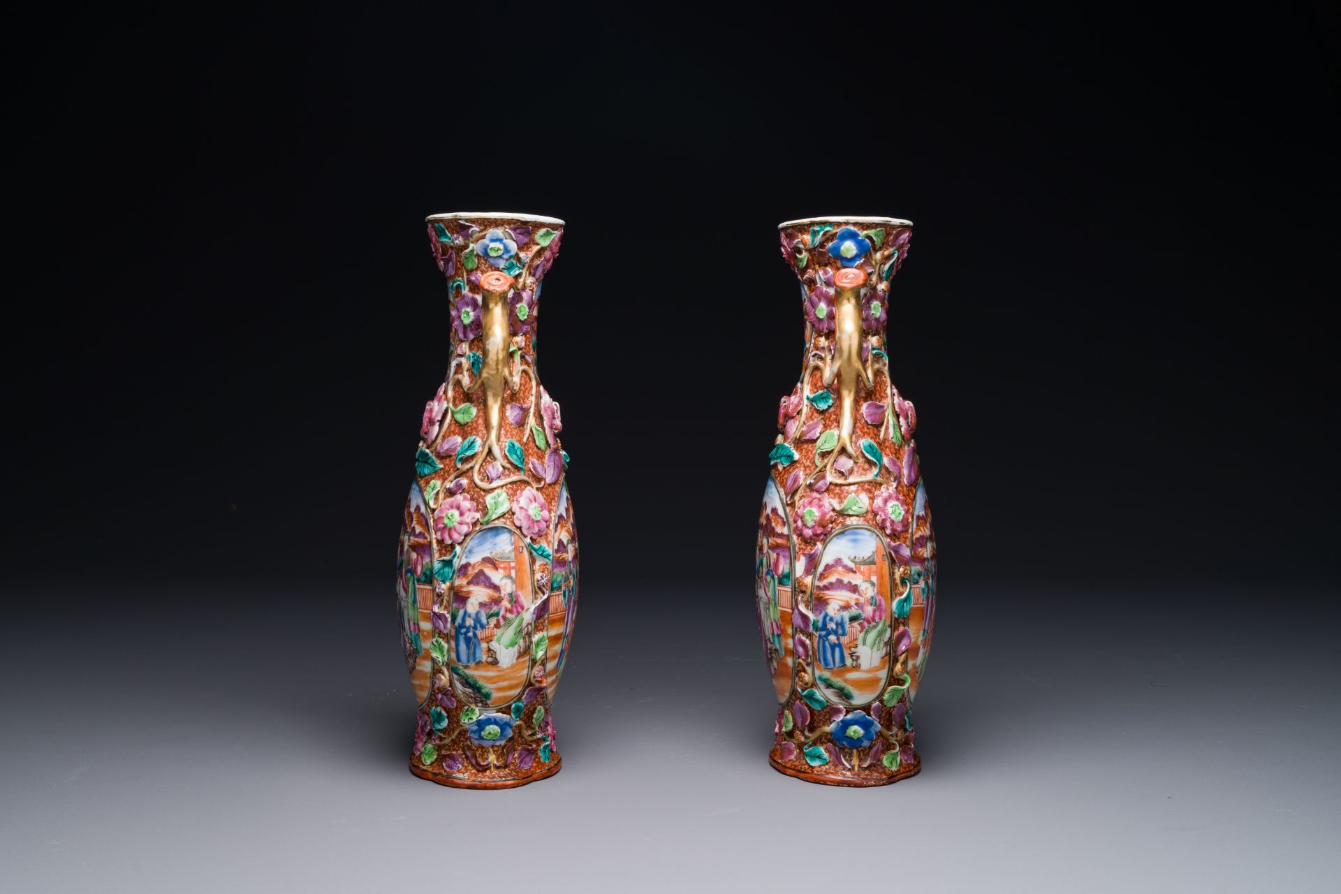 A pair of Chinese Canton famille rose 'mandarin subject' vases with floral relief design, Qianlong - Image 4 of 6