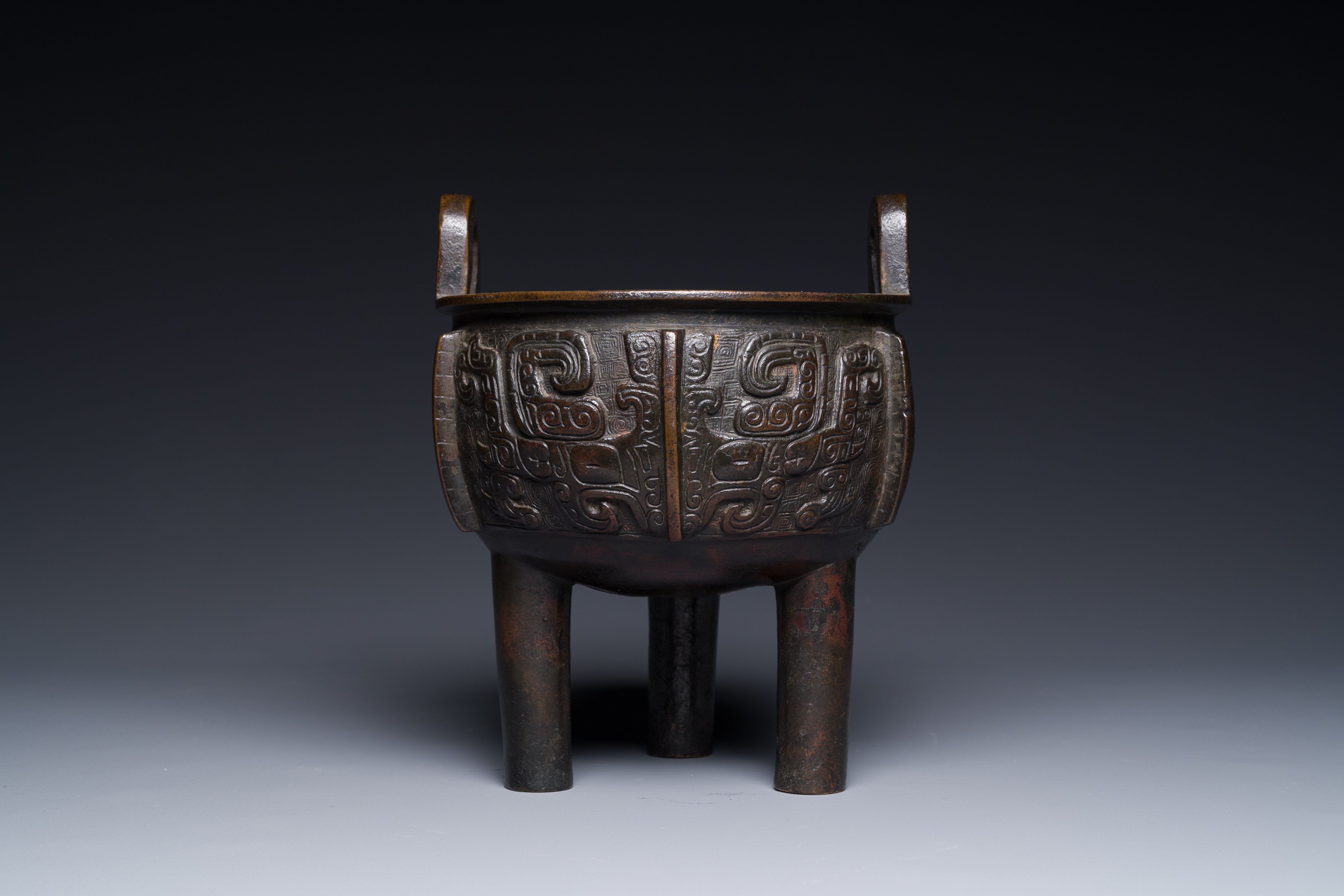 A Chinese archaistic bronze tripod censer on wooden stand, 'ding', Song/Ming - Image 10 of 21