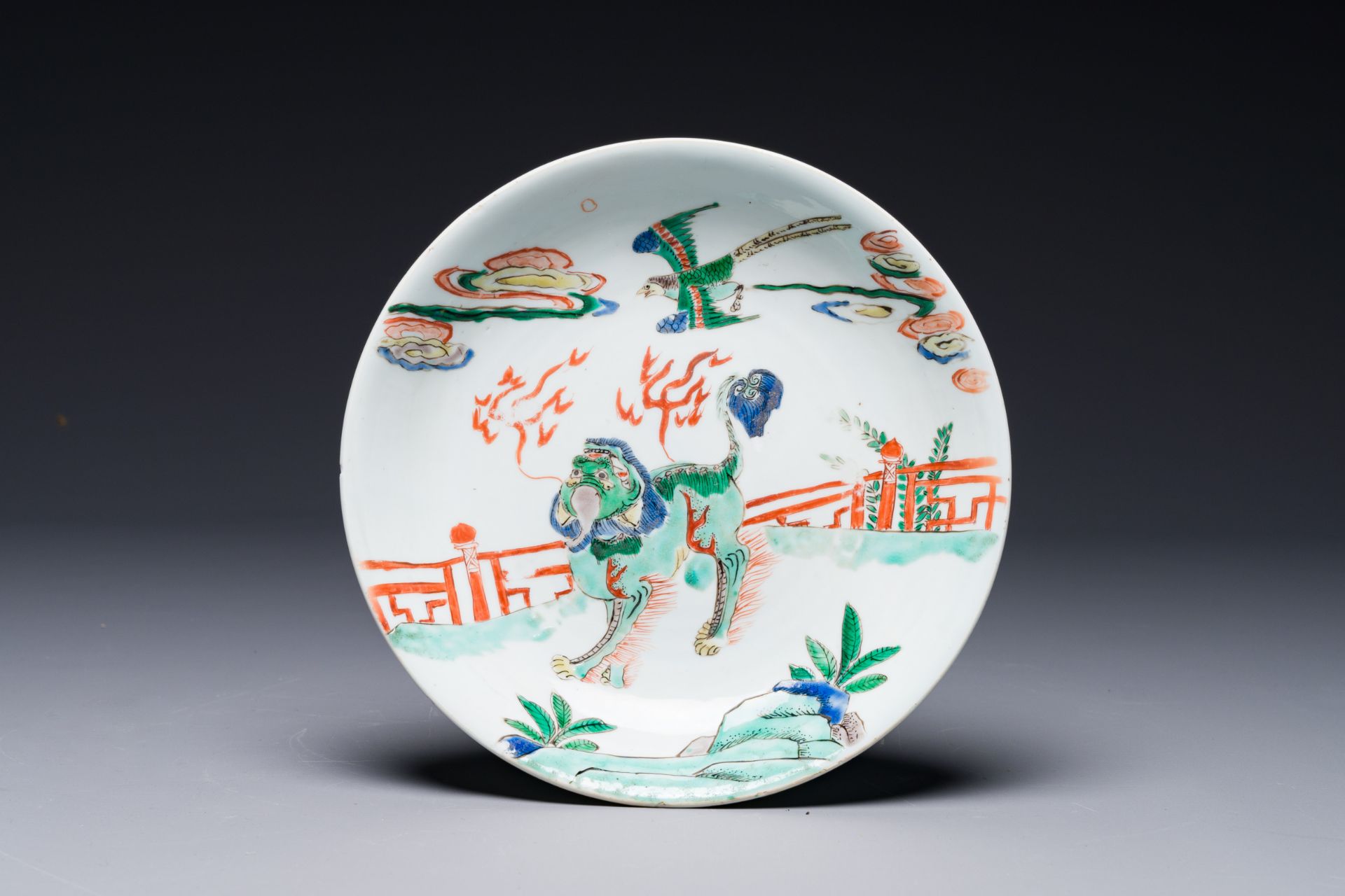 A Chinese famille verte 'qilin and falcon' plate, artemisia leaf mark, Kangxi