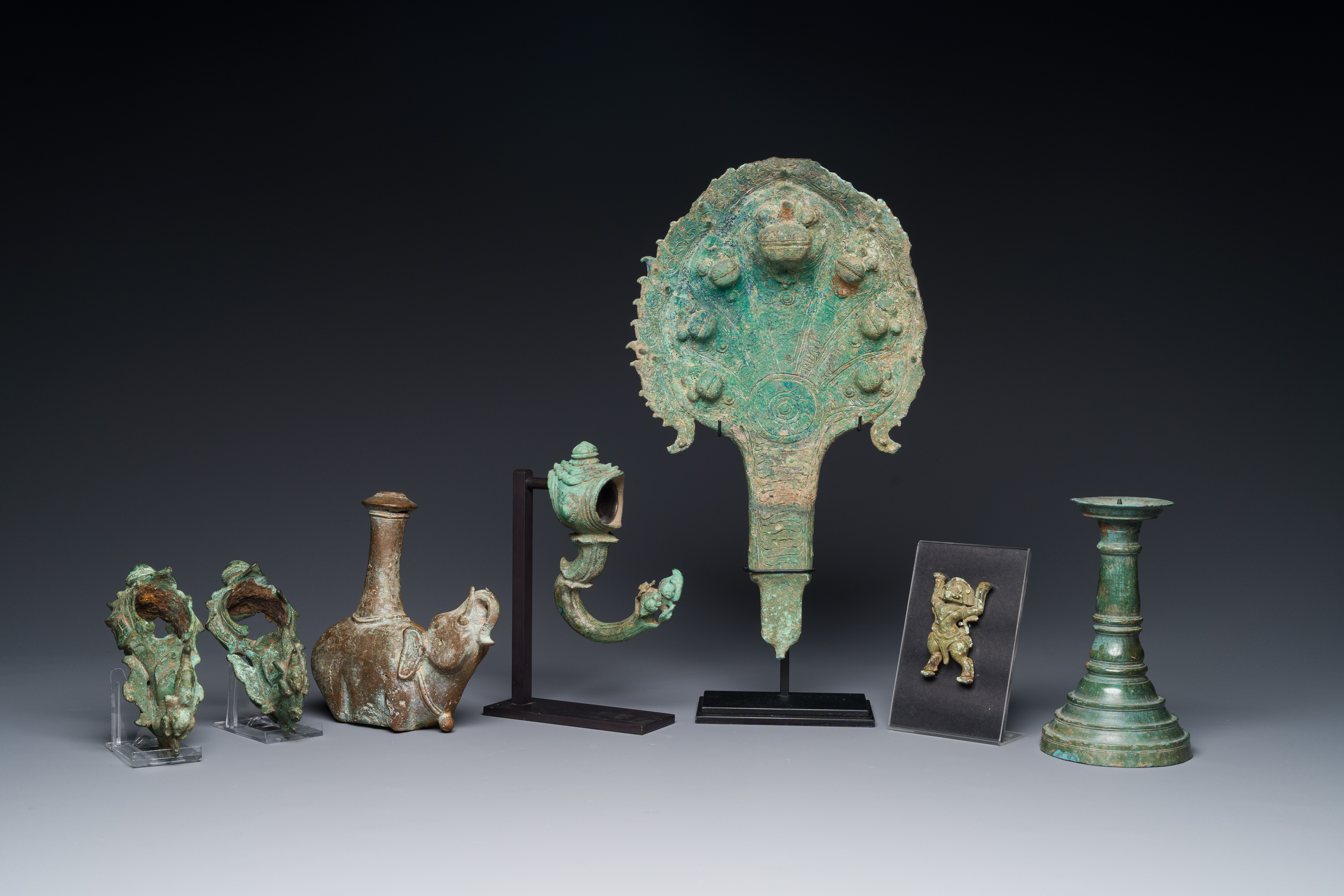 A collection of bronze sculptures, palanquin hooks and a candlestick holder, Cambodia, 13th C. and e - Image 3 of 15