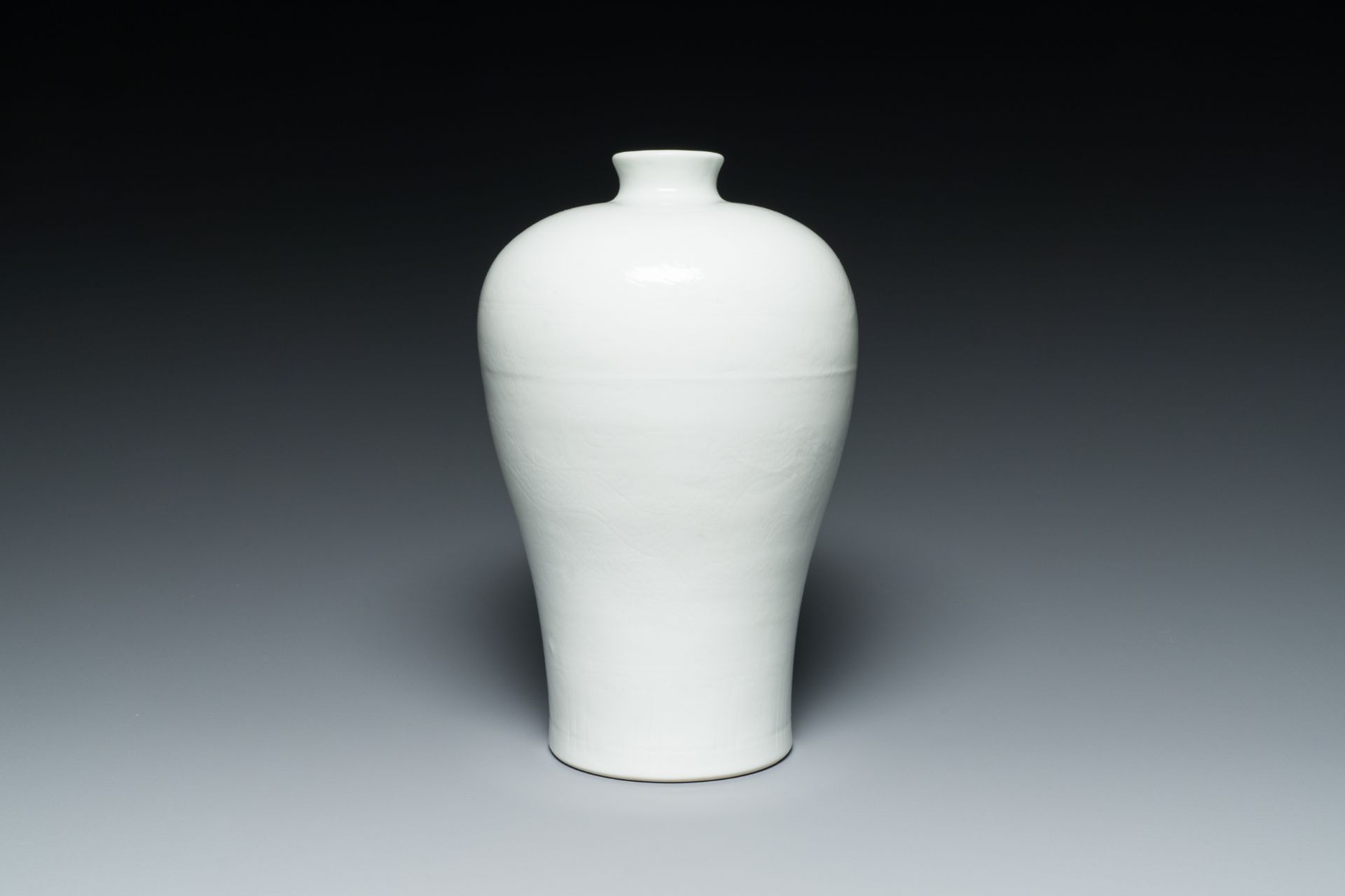 A Chinese monochrome white-glazed 'meiping' vase with anhua dragon design, 19th C.