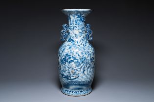 A large Chinese blue, white and copper-red vase with a mountainous river landscape, 19th C.