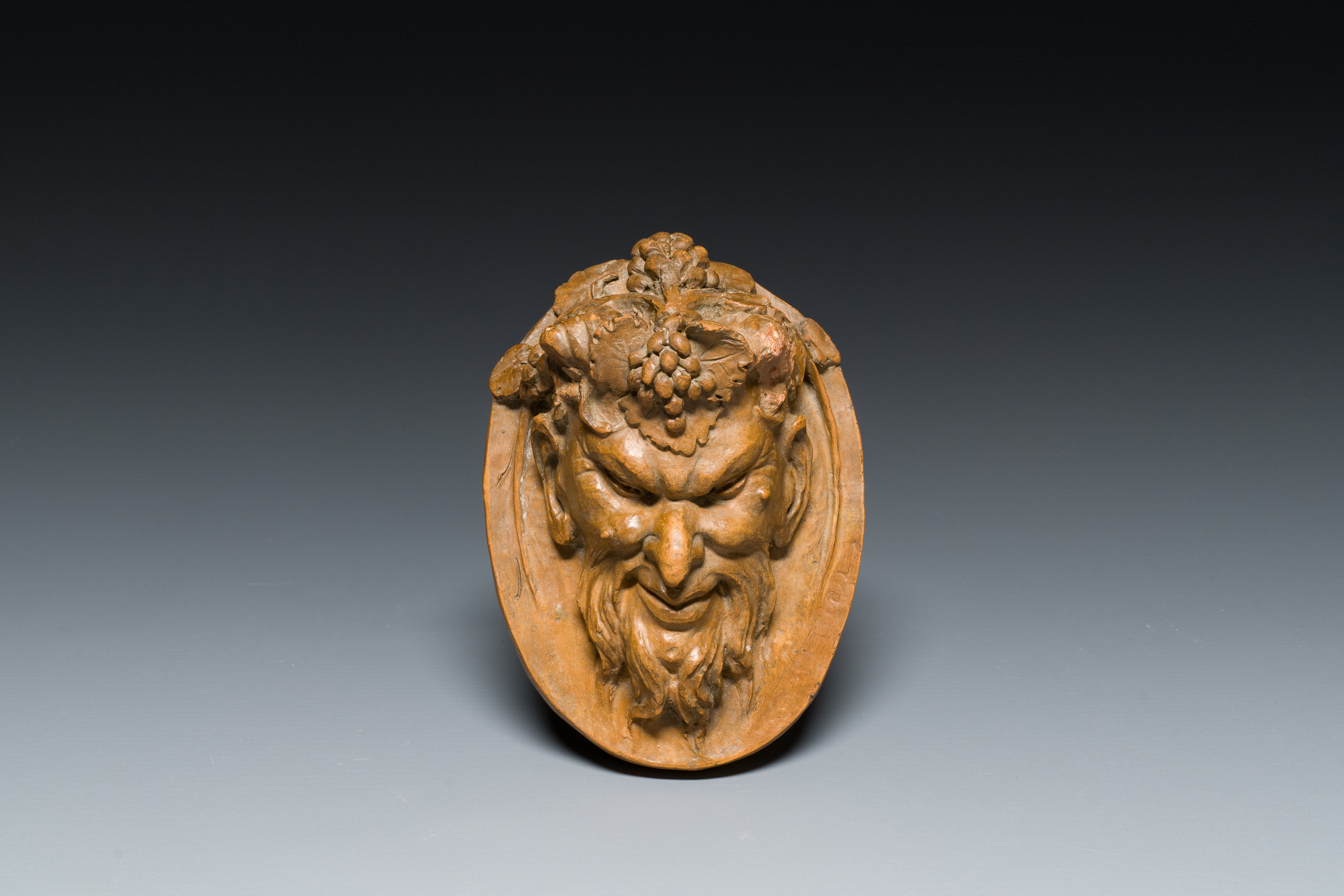 A terracotta head of a faun, signed Clodion, 19th C.