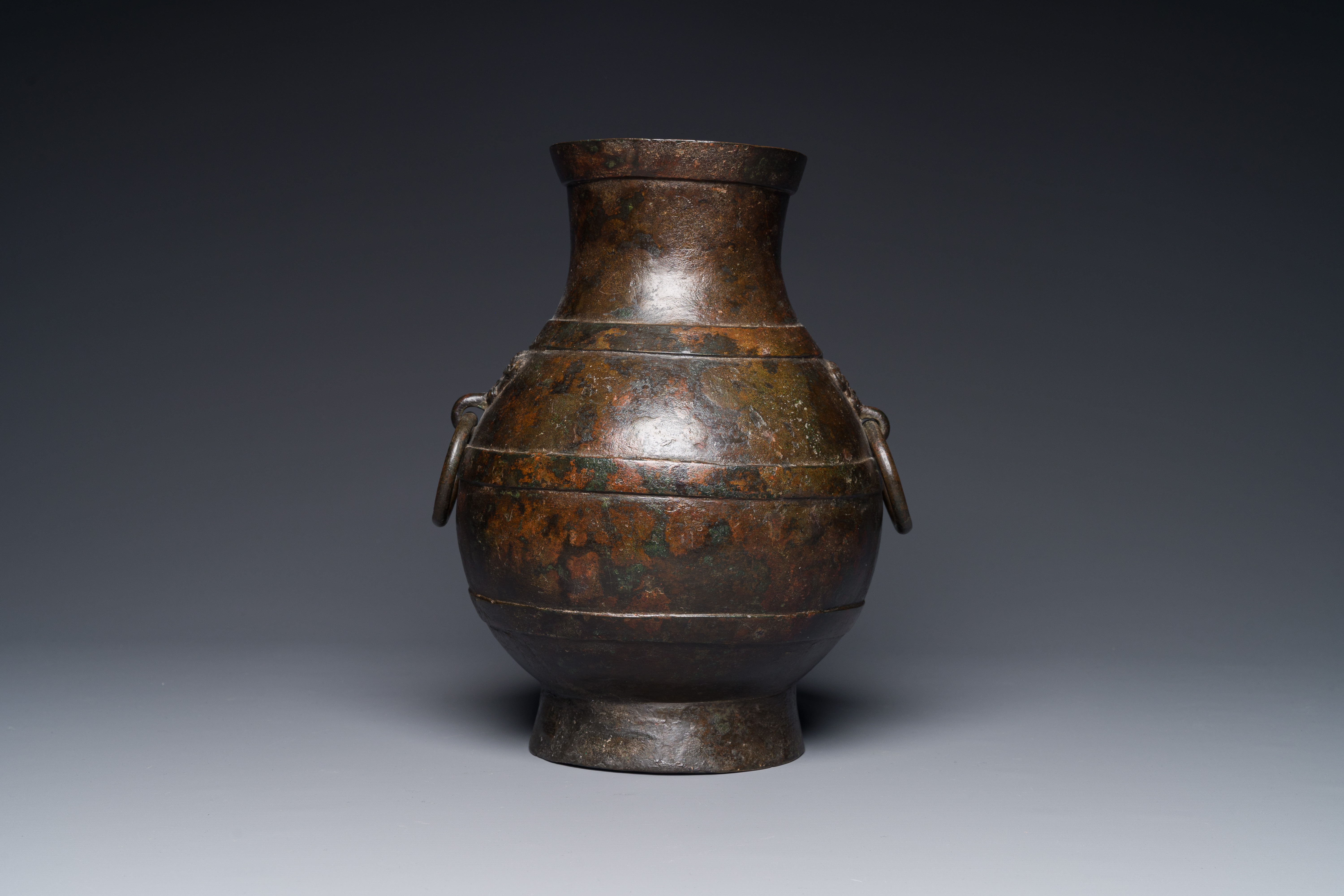 A Chinese bronze 'hu' vase with Han-style taotie handles on wooden base, Ming - Image 4 of 12