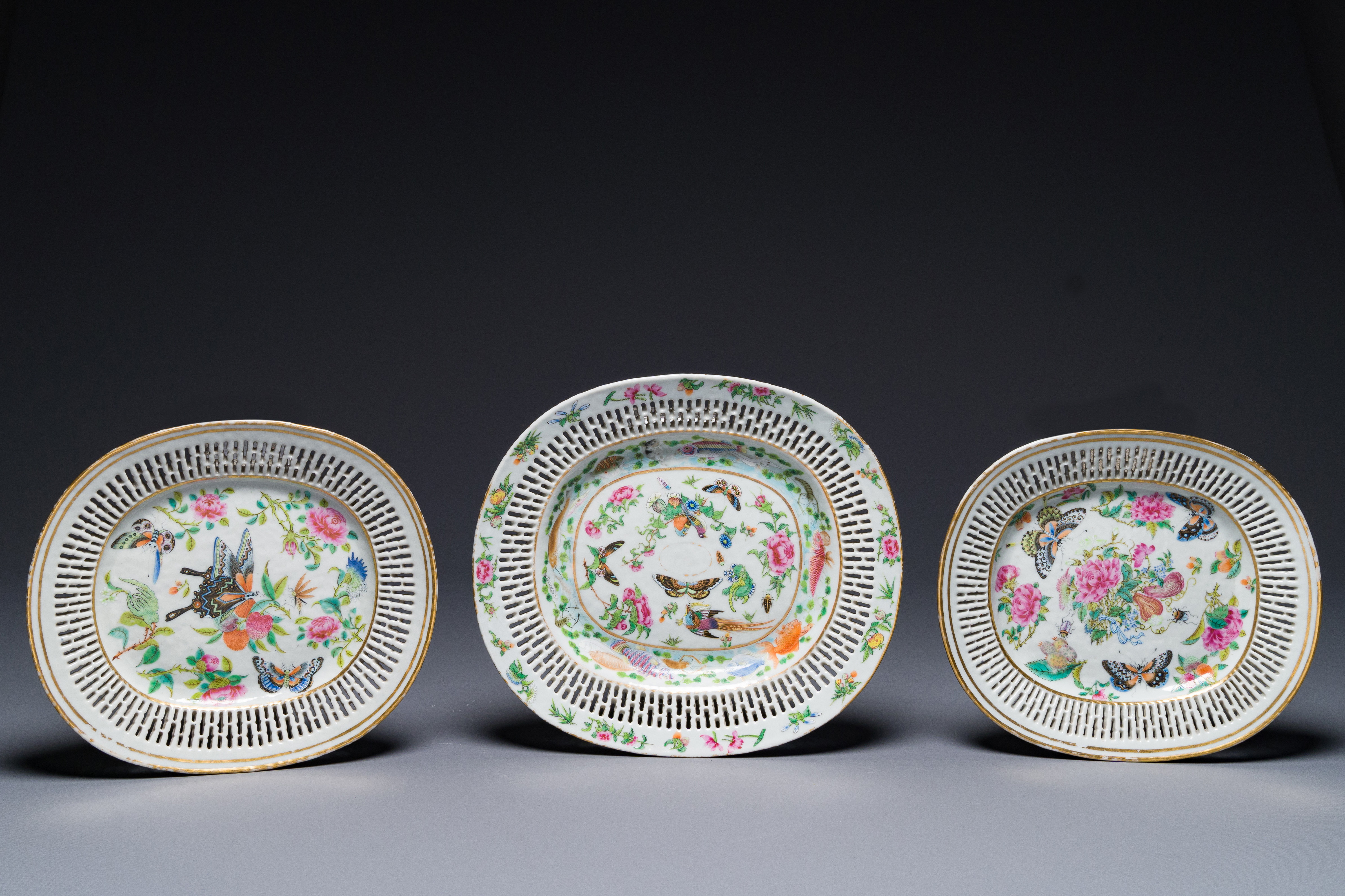 Three Chinese Canton famille rose reticulated oval dishes with flowers, butterflies and marine anima