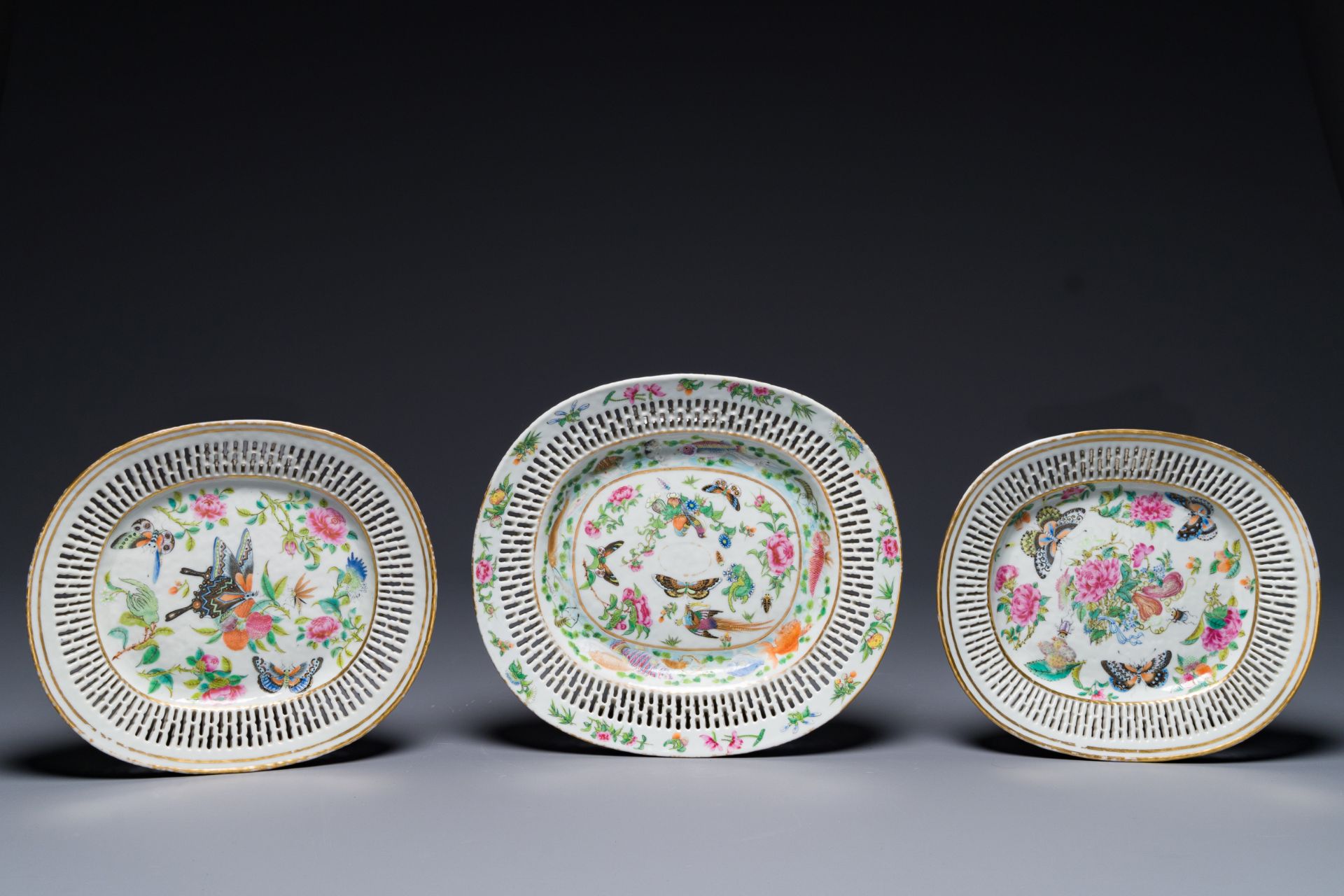 Three Chinese Canton famille rose reticulated oval dishes with flowers, butterflies and marine anima