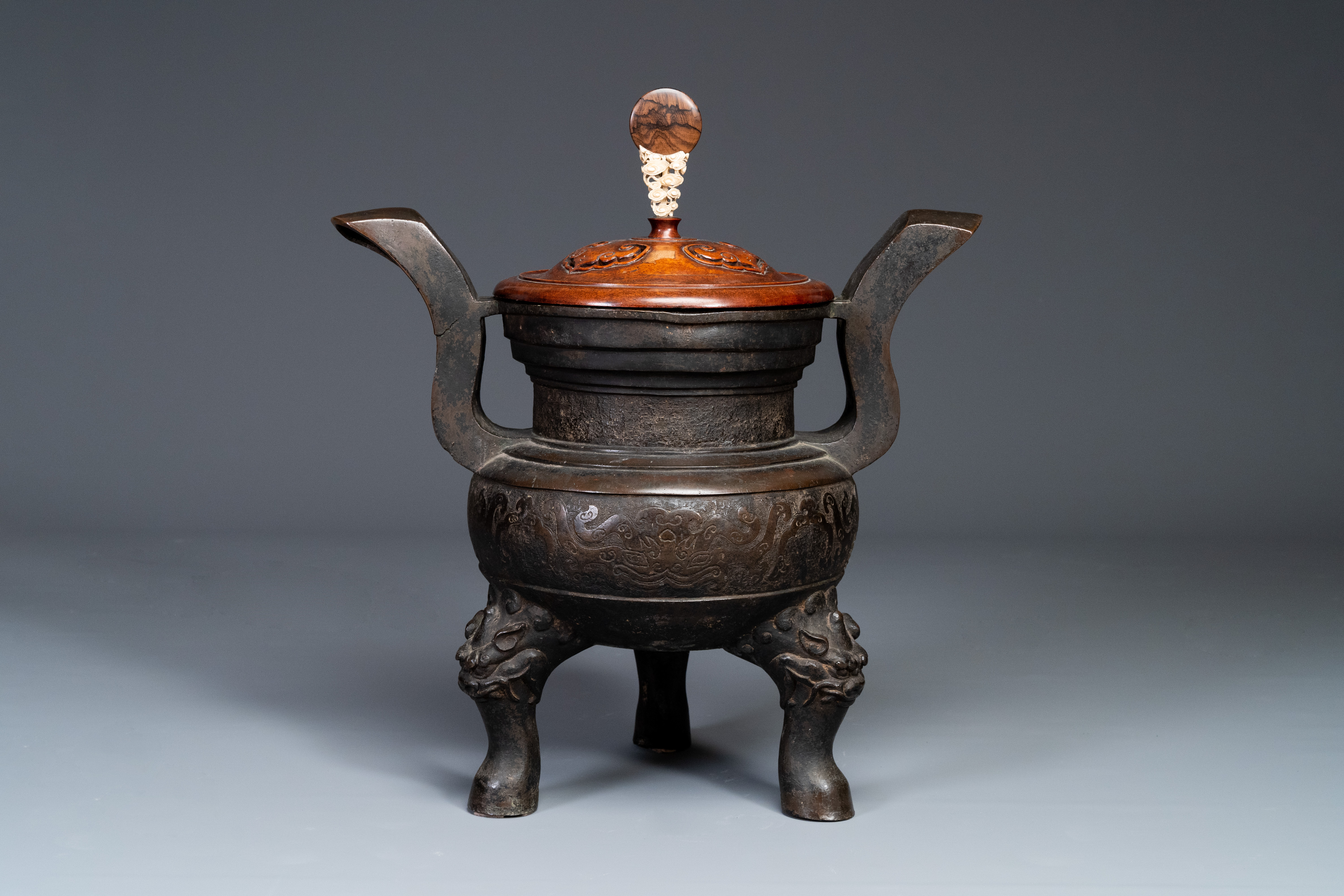 An important Chinese bronze tripod 'taotie' censer with wooden lid, Ming - Image 9 of 18