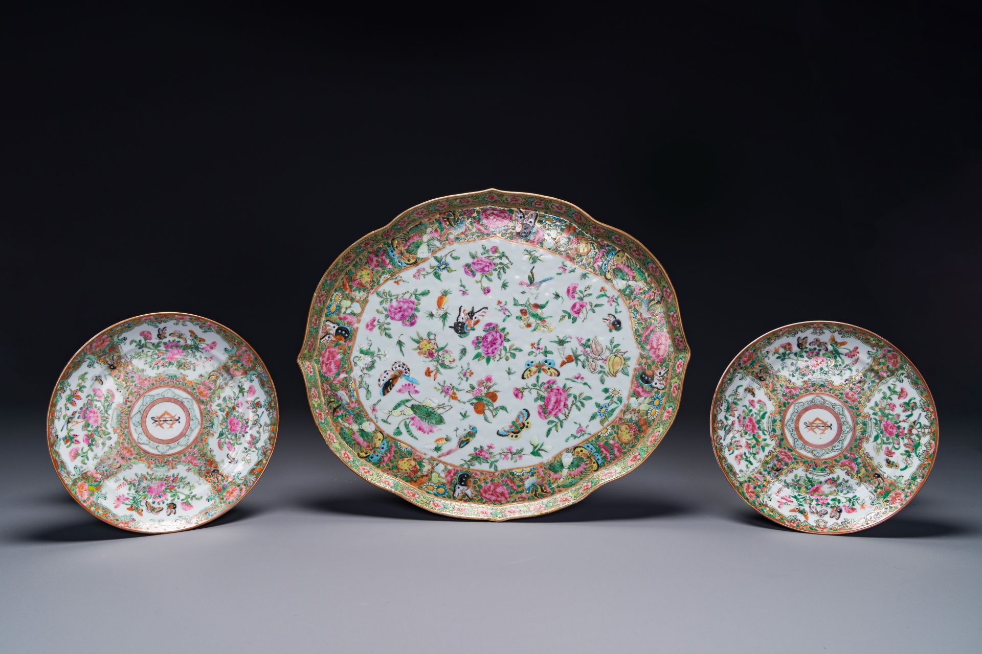 A pair of Chinese Canton famille rose monogrammed plates and a large '100 butterflies' tray, 19th C.