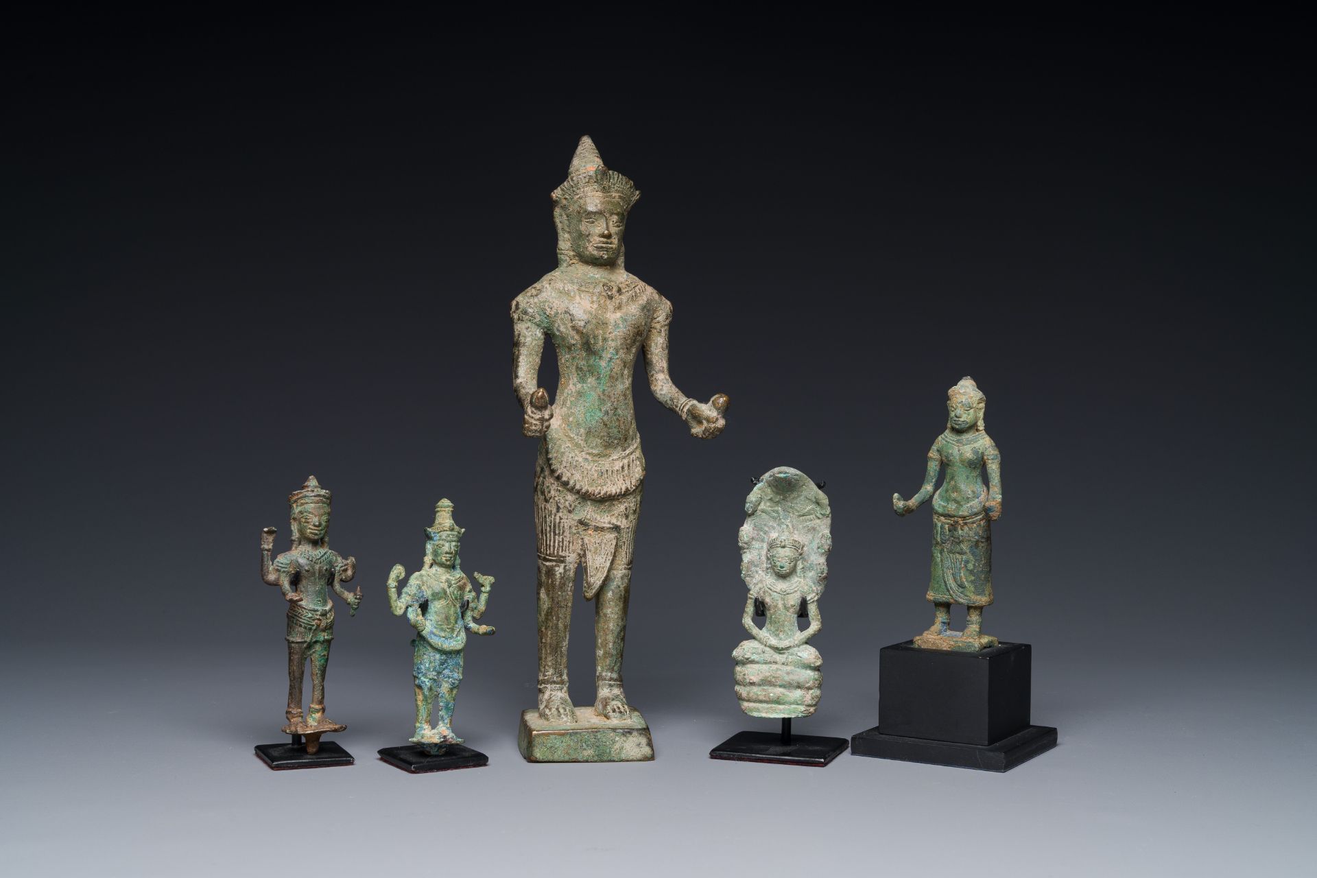 A group of five bronze figures of Shiva, Bodhisattva and Uma, Cambodia, 11/16th C.