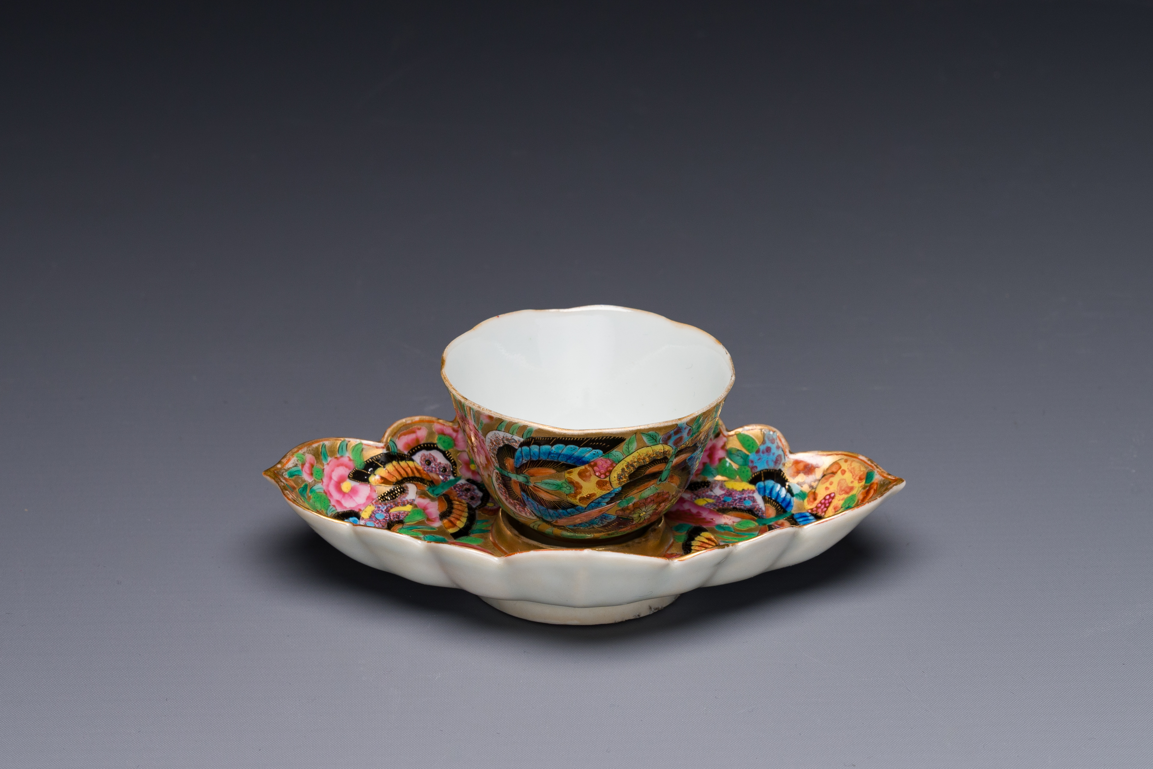 A Chinese Canton famille rose gilt-decorated cup and stand with flowers and butterflies, 19th C. - Image 2 of 5