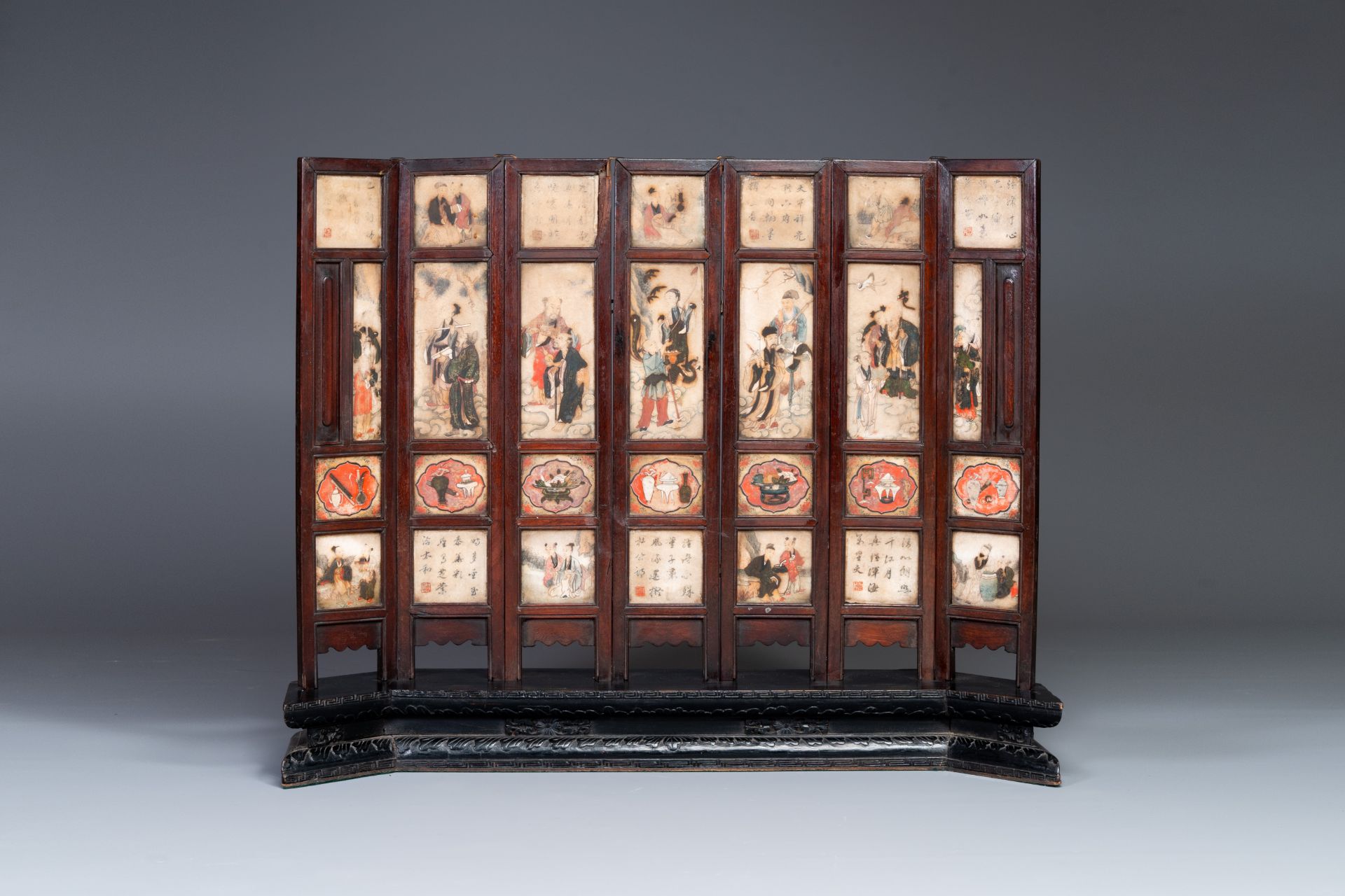 A Chinese seven-fold wooden table screen with painted marble plaques, 19th C.