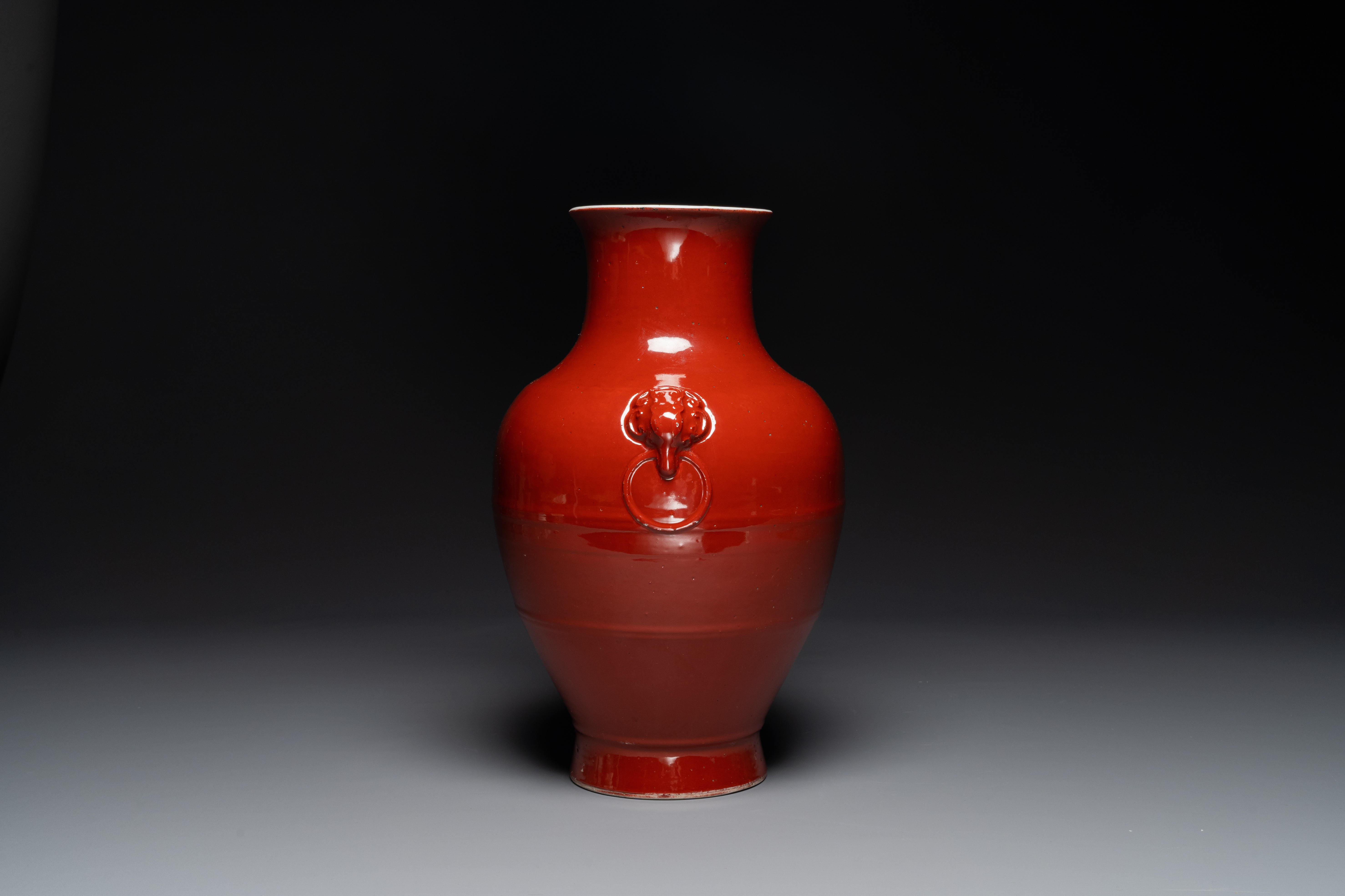 A Chinese monochrome red-glazed 'hu' vase, Qianlong mark, 19th C. - Image 2 of 6