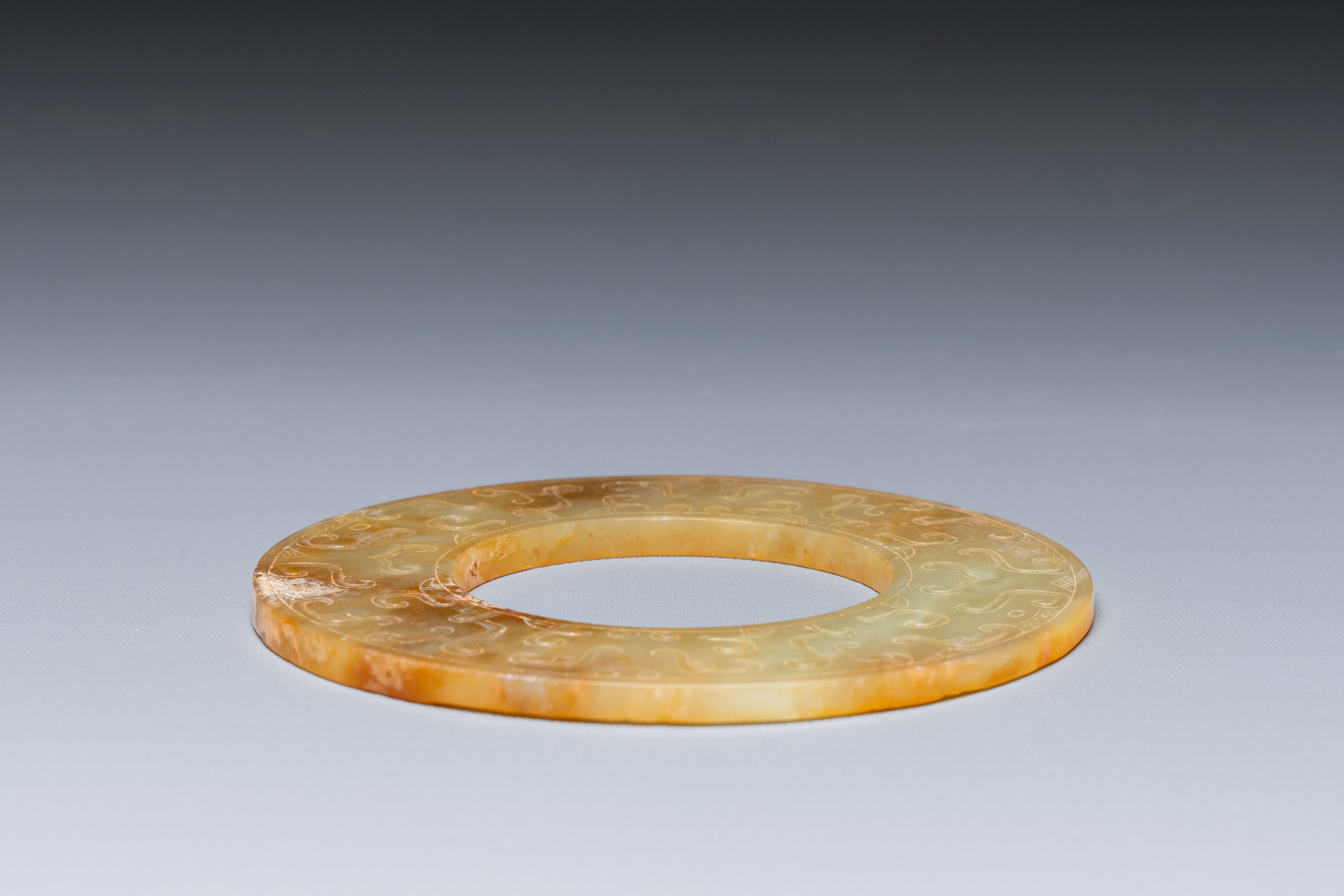 A Chinese celadon and russet jade 'bi' disc, probably Han - Image 4 of 4