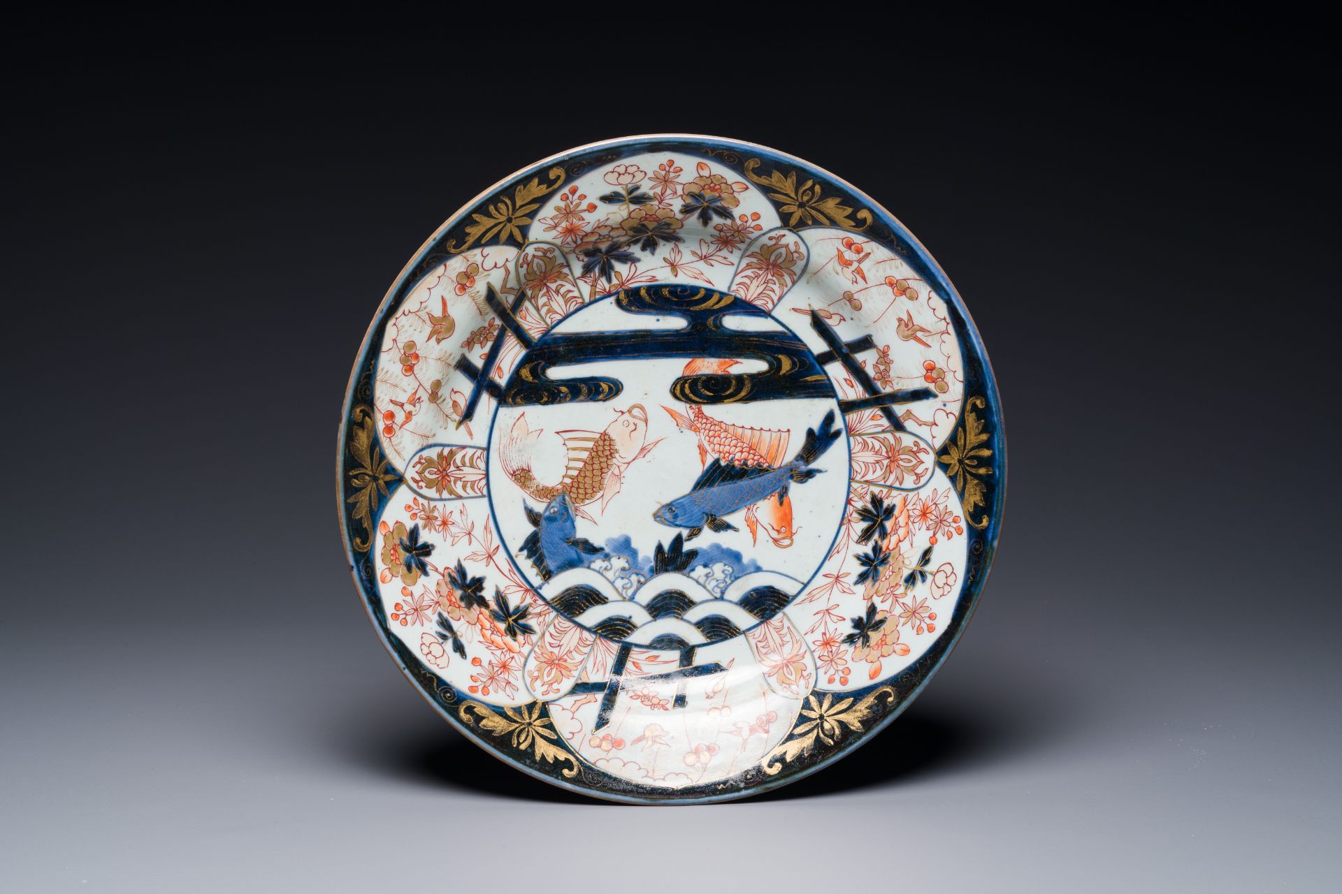 A Japanese Imari dish with carps among waves and clouds, Edo, 17th C.