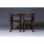A pair of large Chinese carved wooden stands with marble tops, 19th C.