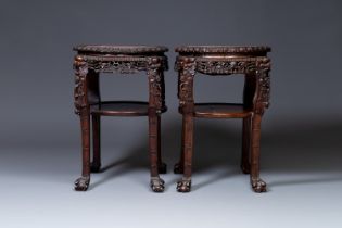 A pair of large Chinese carved wooden stands with marble tops, 19th C.